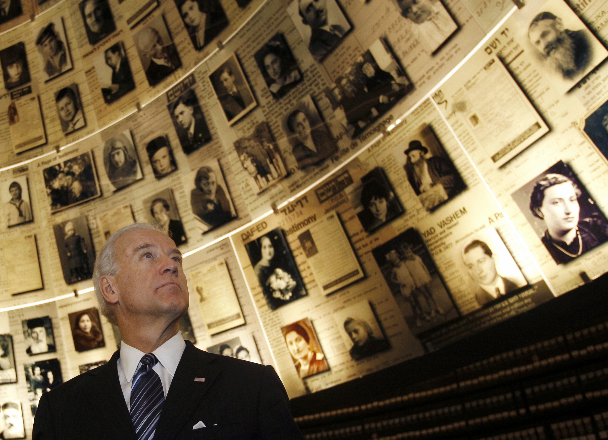Biden looks at pictures of Jews killed in the Holocaust during a visit to the Yad Vashem Holocaust History Museum in Jerusalem in 2010