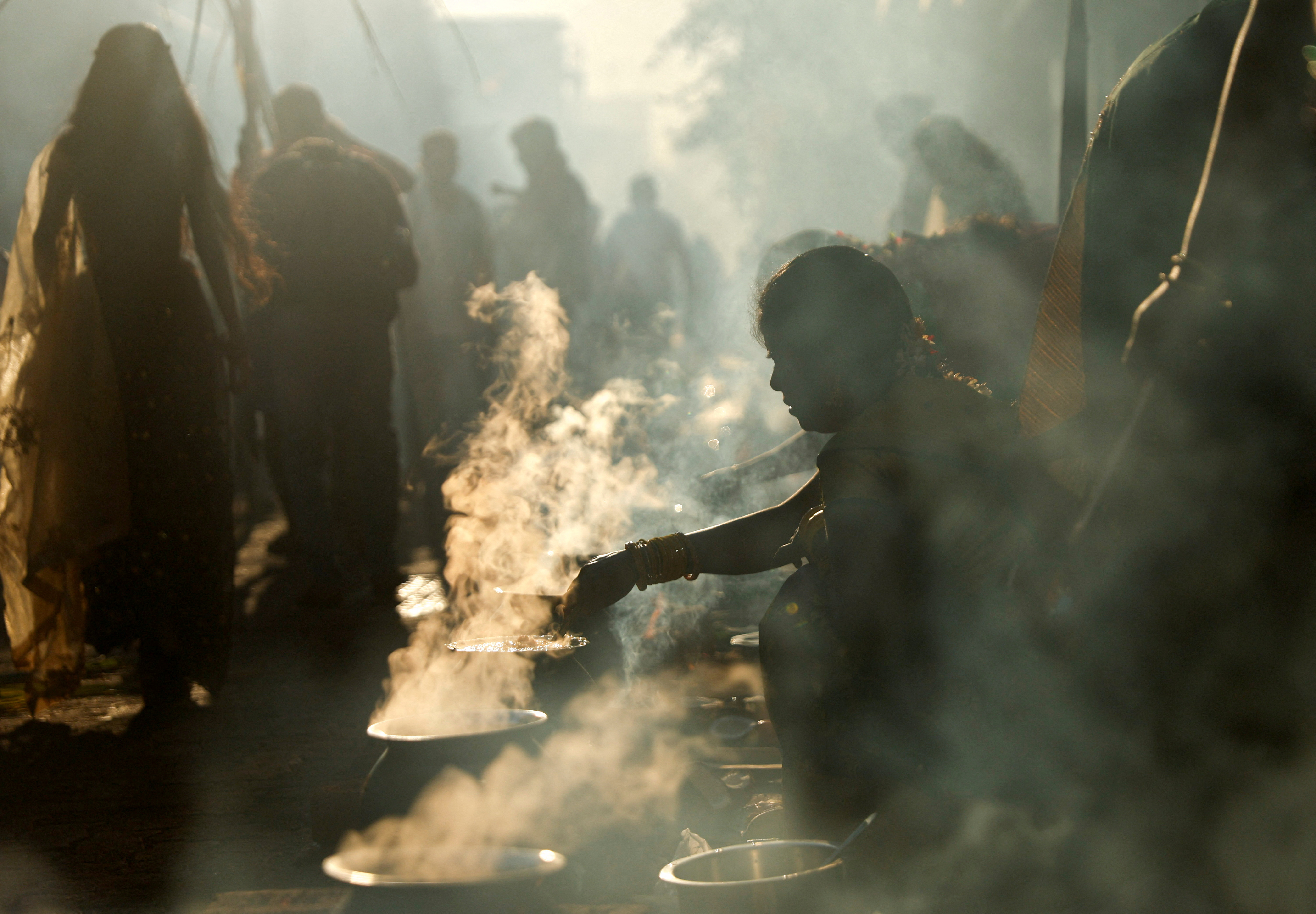 Devotees cook a rice dish as an offering to the Hindu sun god during Pongal celebrations on a street in Mumbai, India, January 15
