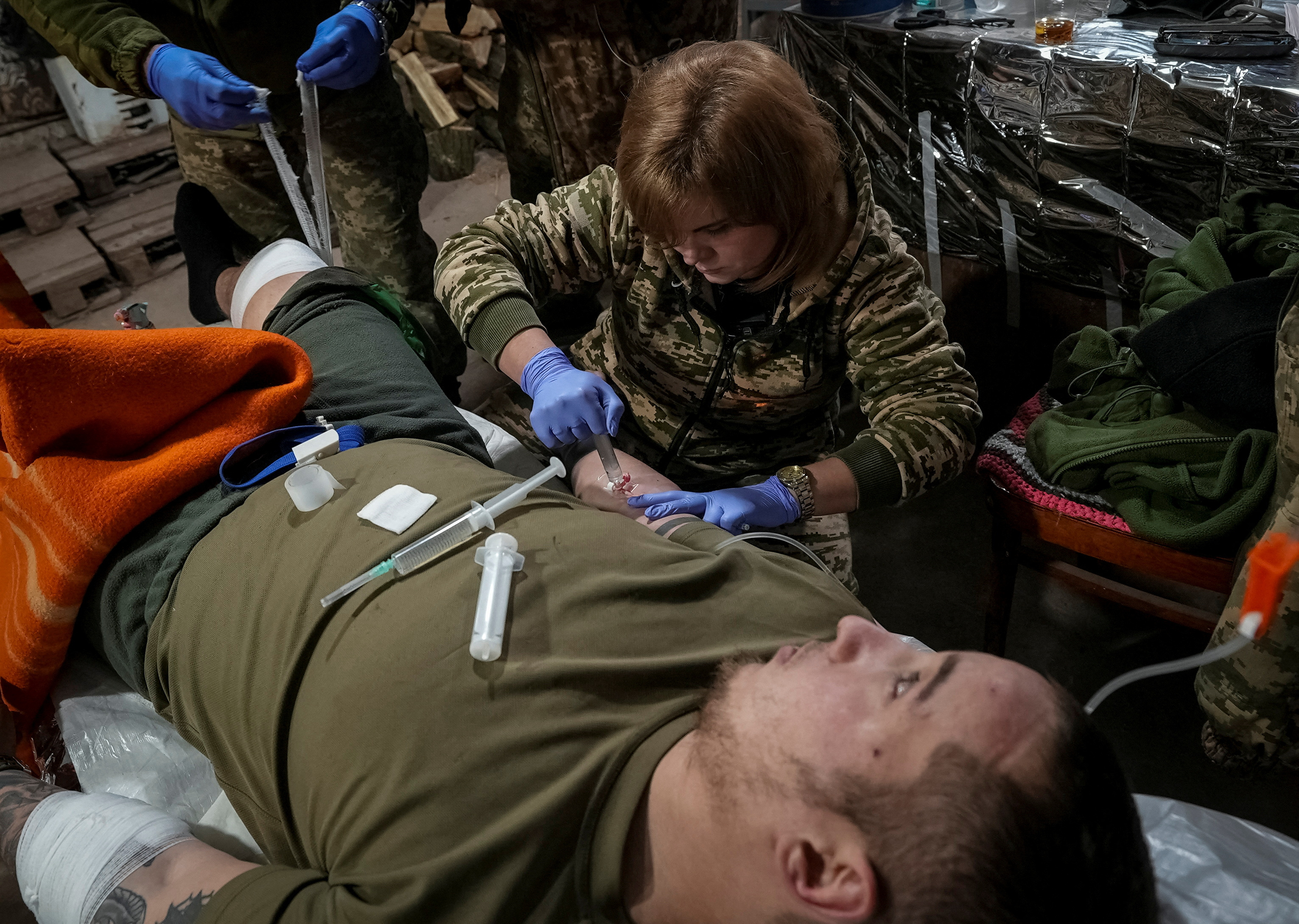 A medic treating an injured Ukrainian soldier