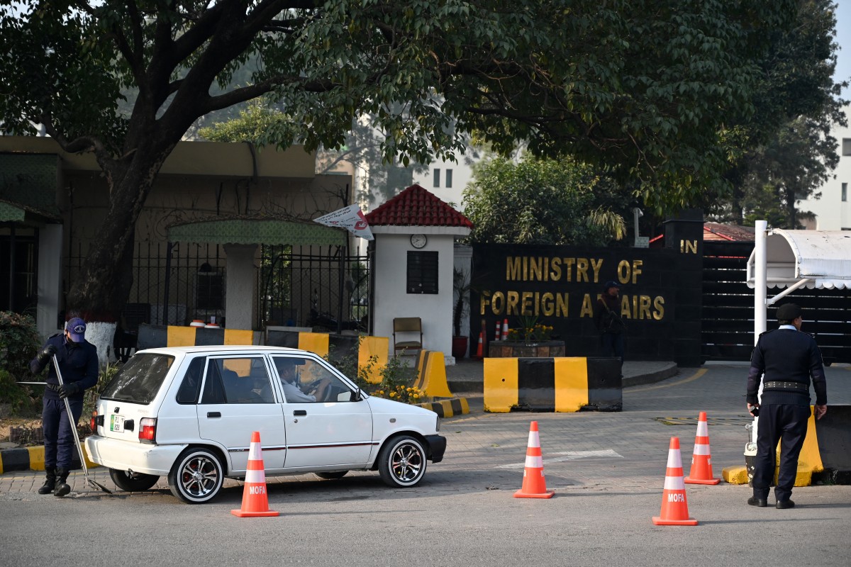 A Pakistani police officer checks a vehicle entering the Ministry of Foreign Affairs in Islamabad on January 18, 2024