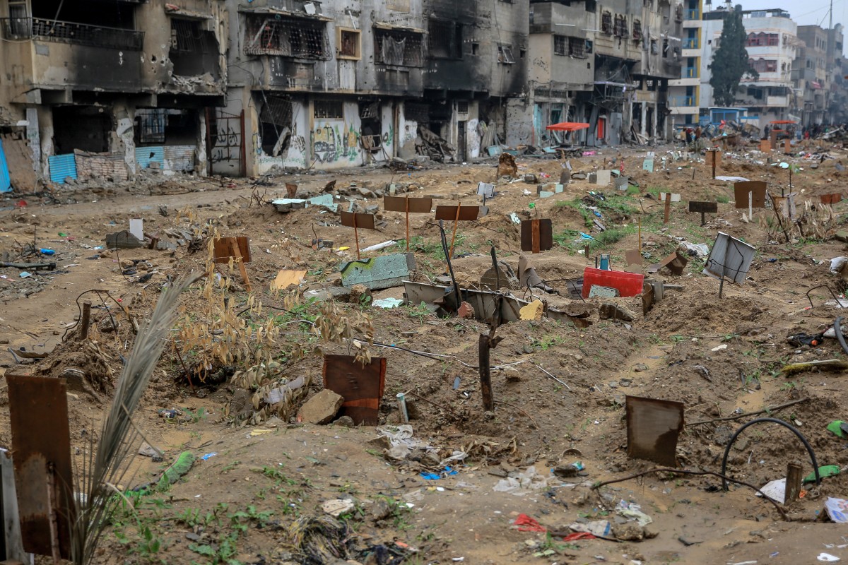 Placards indicate the names of the diseased at a makeshift cemetery
