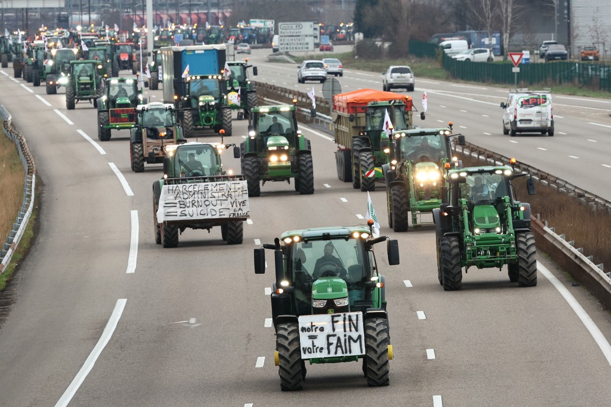 Farmers drive their tractors during a protest