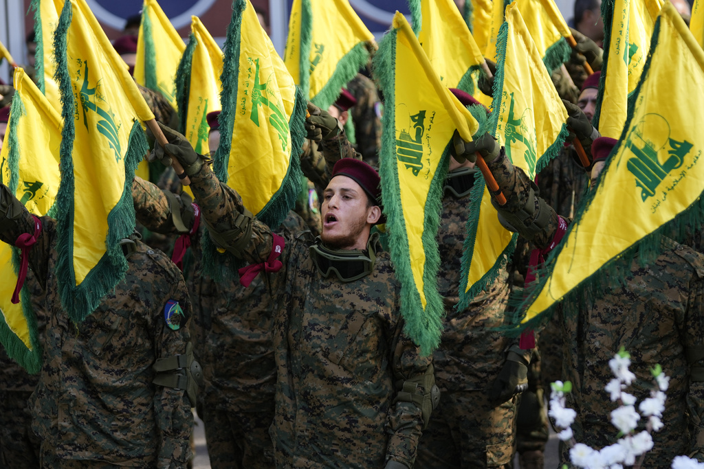 Hezbollah fighters attend the funeral of their commander Wissam al-Tawil, in the village of Khirbet Selm, south Lebanon, Tuesday, Jan. 9, 2024. The elite Hezbollah commander who was killed in an Israeli airstrike Monday in southern Lebanon fought for the group for decades and took part in some of its biggest battles. (AP Photo/Hussein Malla)
