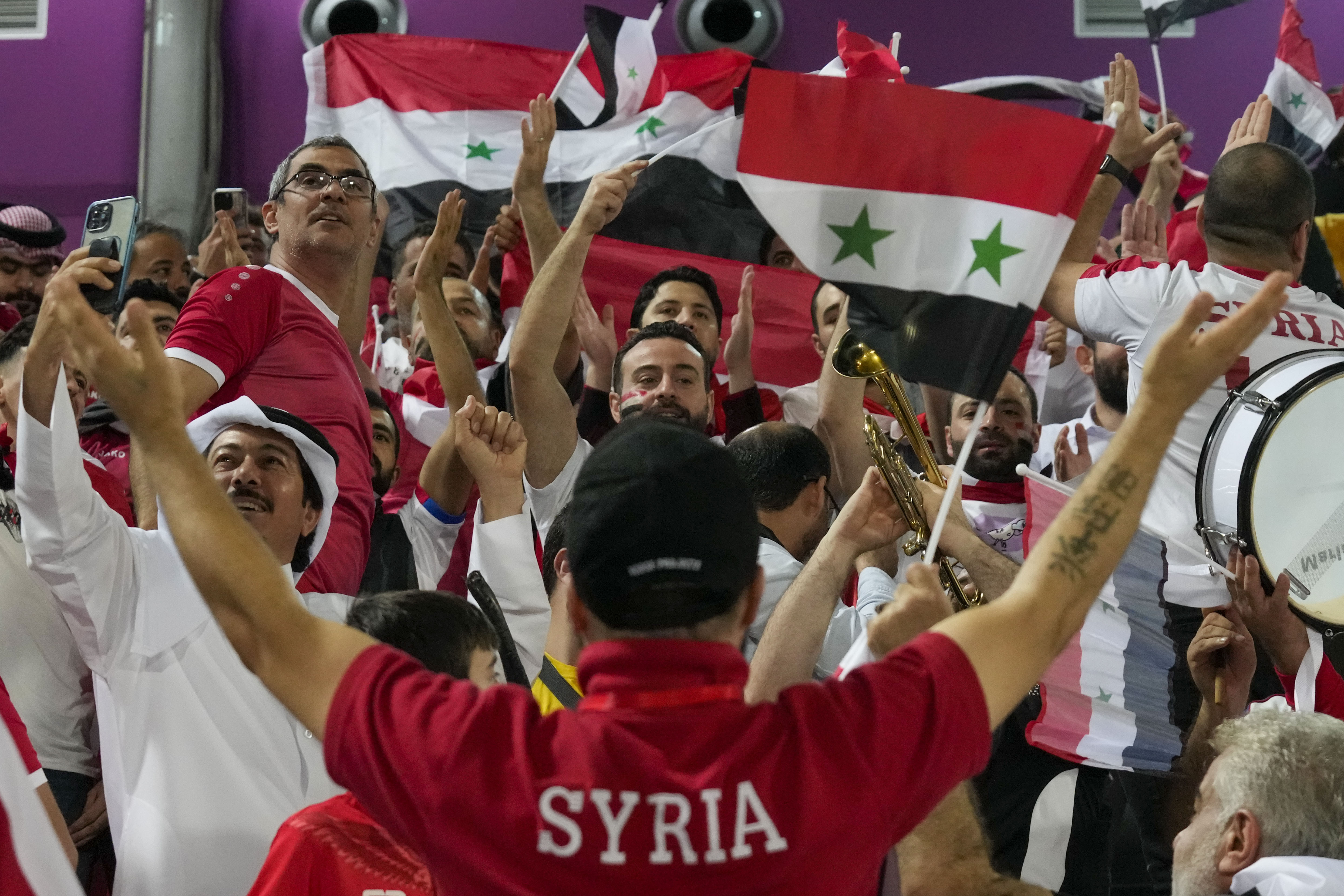 Syrian fans chant at Abdullah Bin Khalifa Stadium in Doha, Qatar