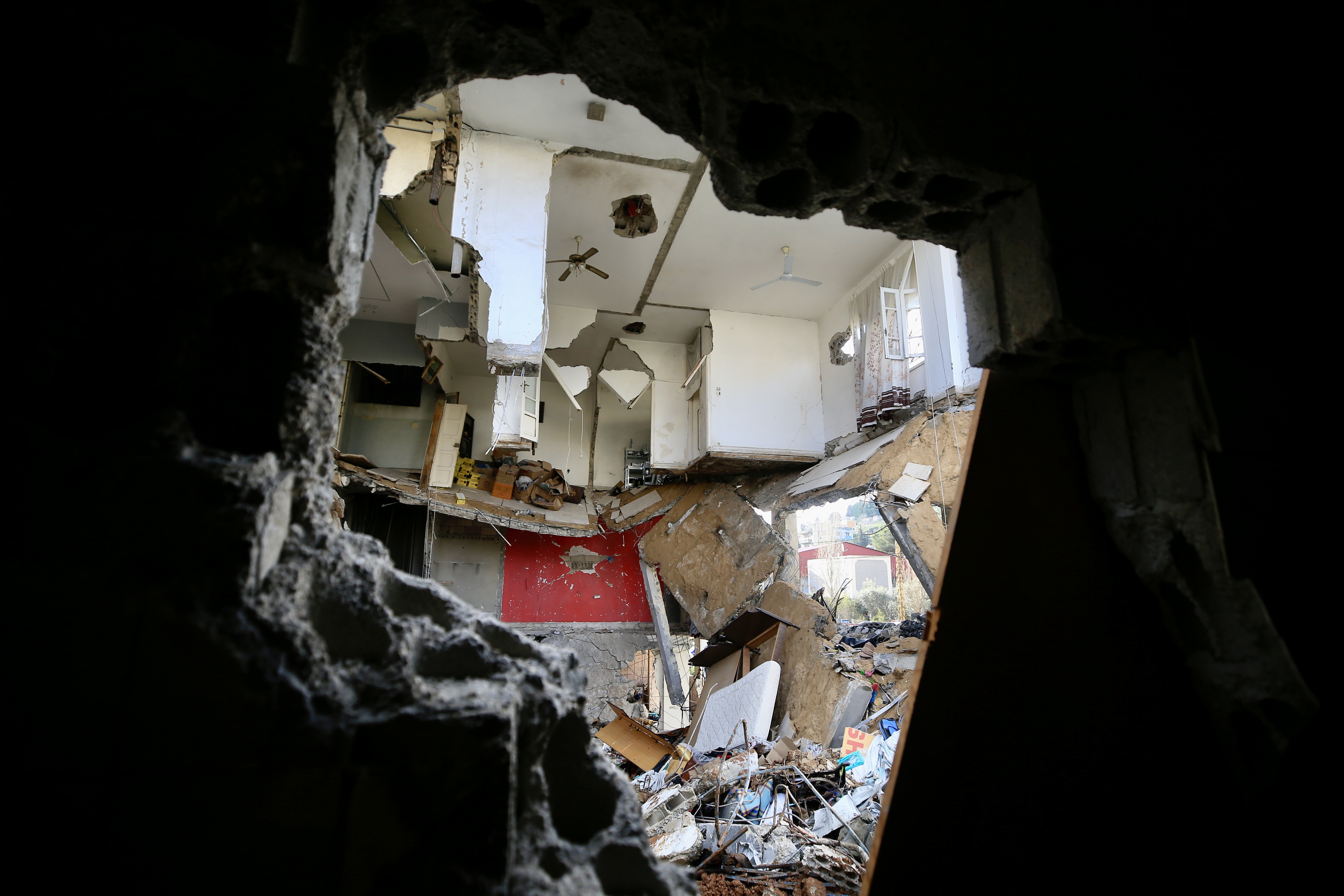 Rescuers work at a damaged buidling following an Israeli military strike in Nabatiyeh