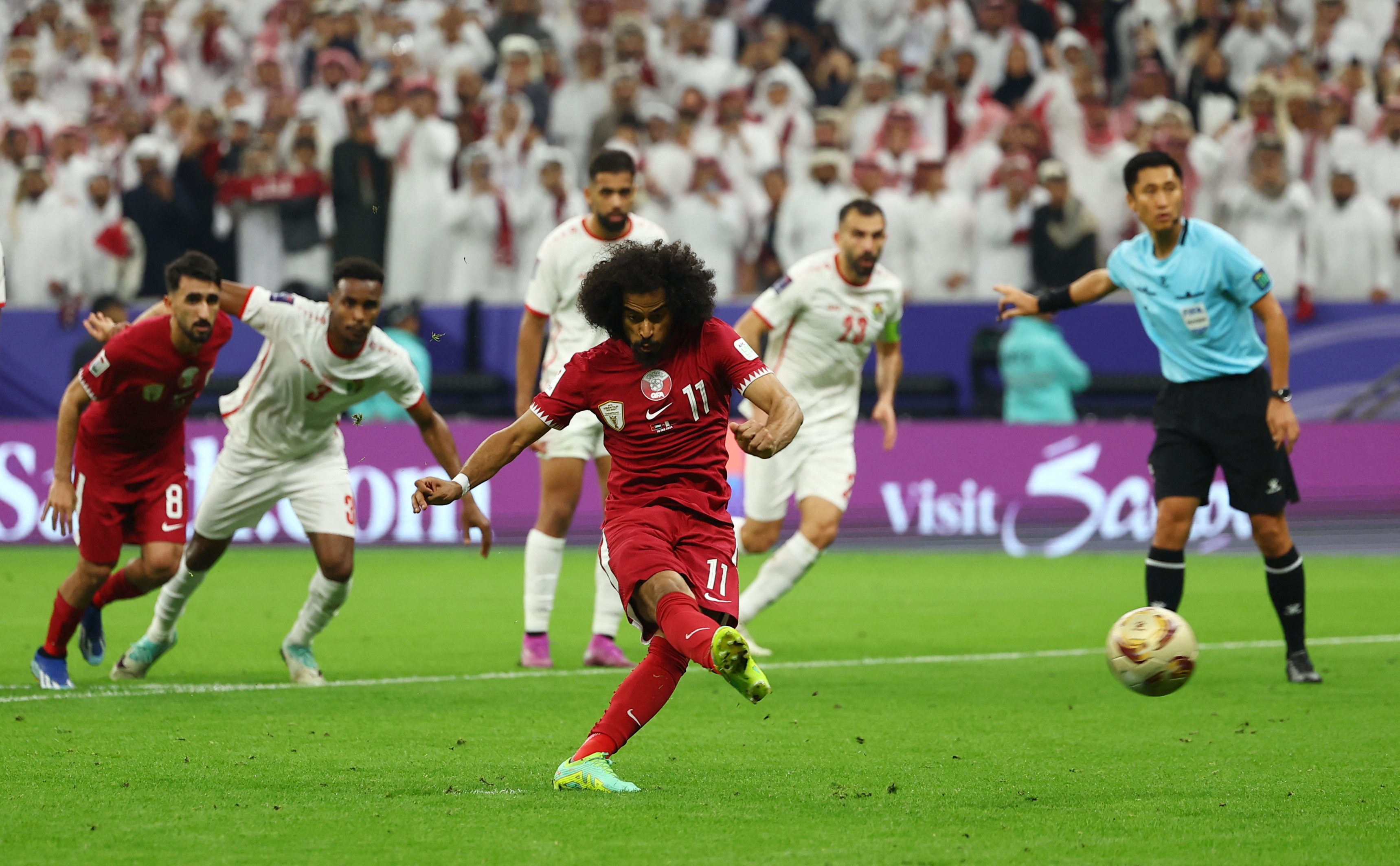 Qatar's Akram Afif scores their second goal from the penalty spot