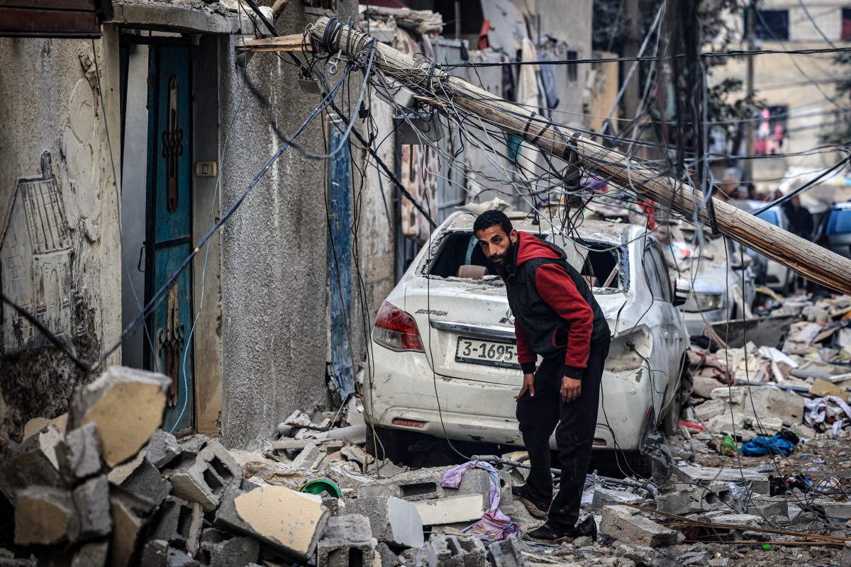 A man stands amid the destruction in the aftermath of Israeli bombardment in Rafah