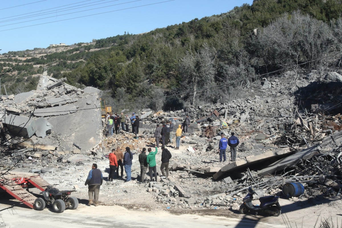 Residents and rescuers check the destruction after an overnight Israeli bombardment in the southern Lebanese village of Kafra