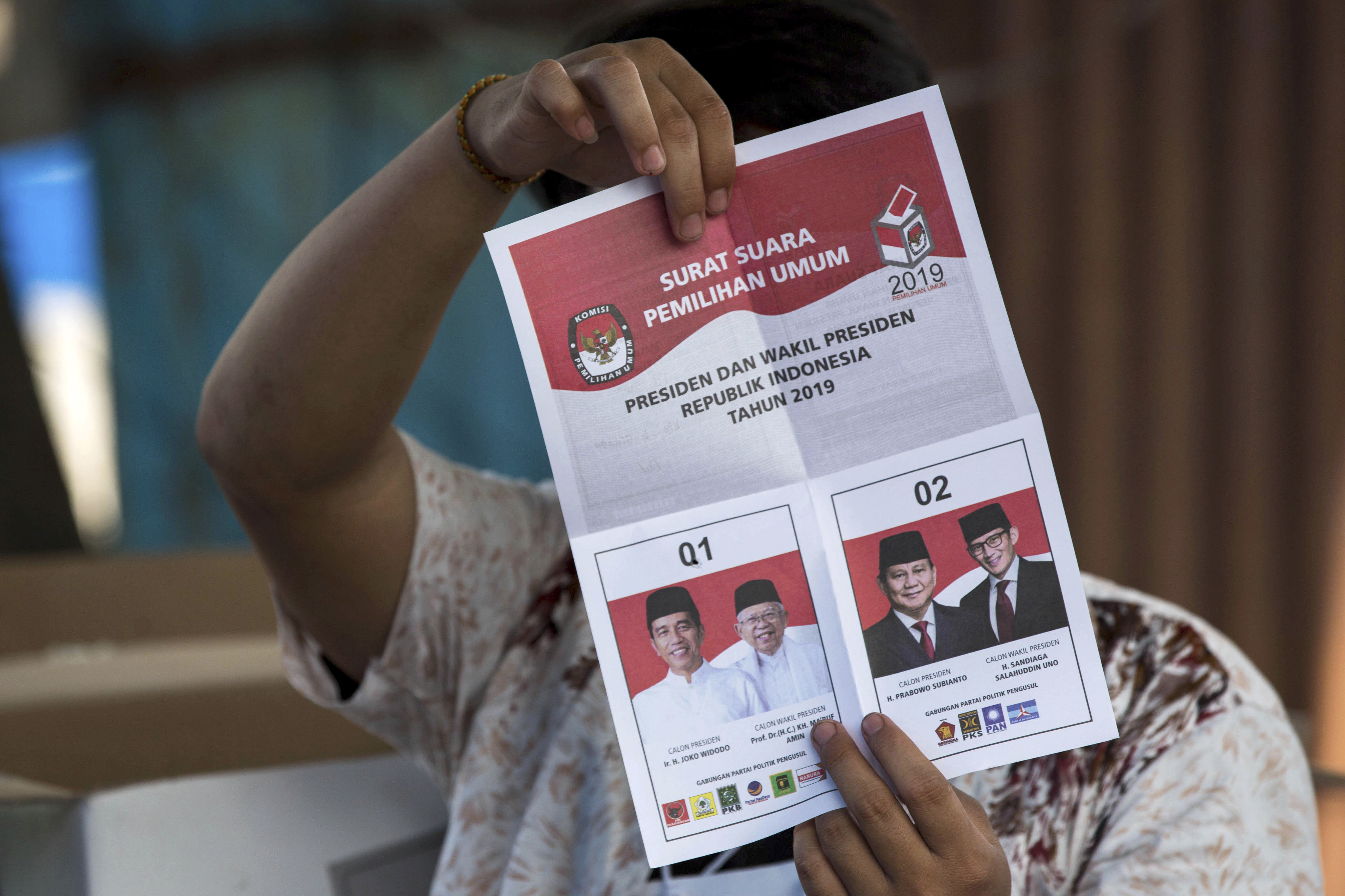 A ballot paper from 2019 showing a hole in Jokowi's box to indicate a vote for him.