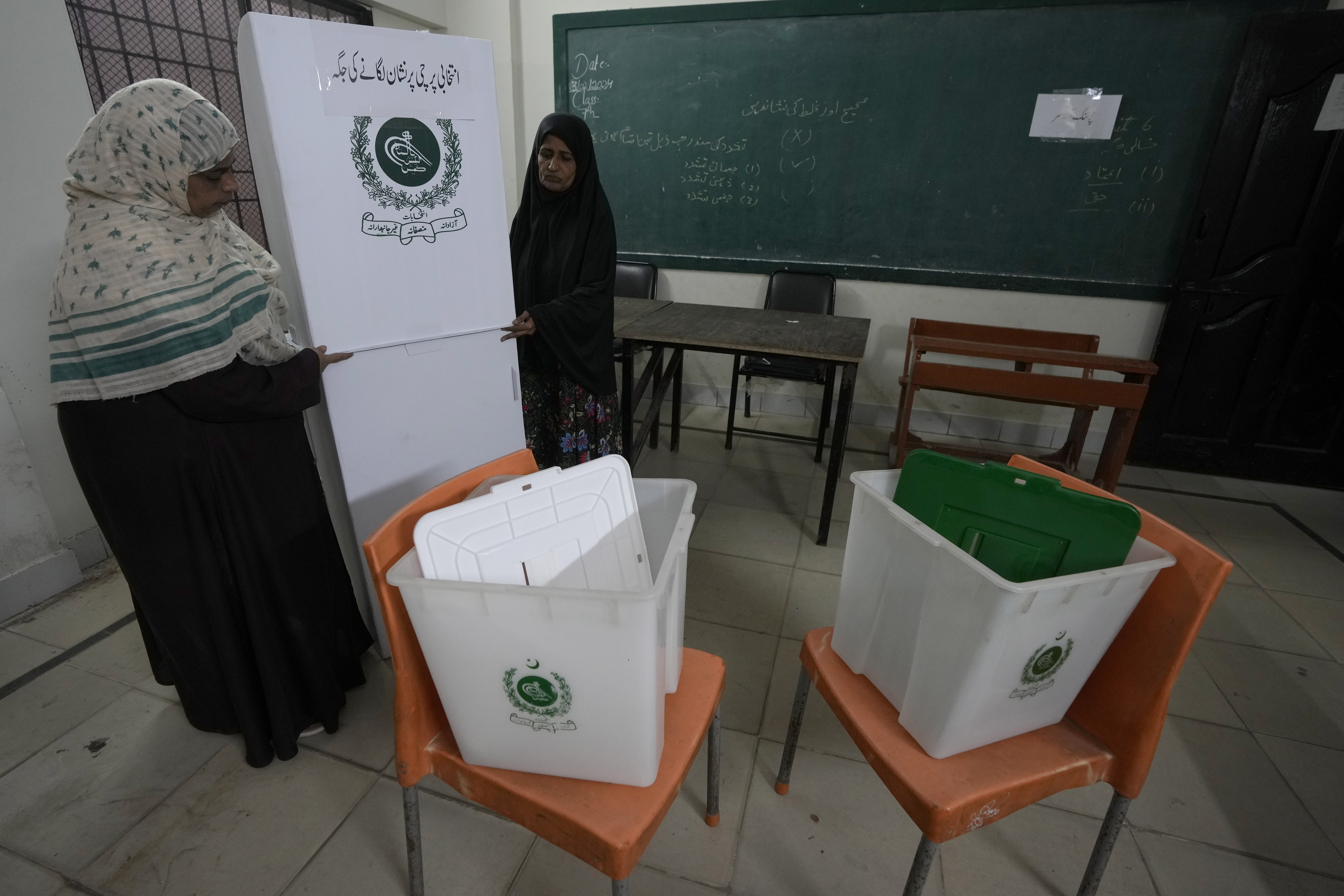 Members of the polling staff set up a polling station in a school building for the February 8 parliamentary elections, in Karachi, Pakistan, Wednesday, February 7, 2024 [Fareed Khan/AP Photo]