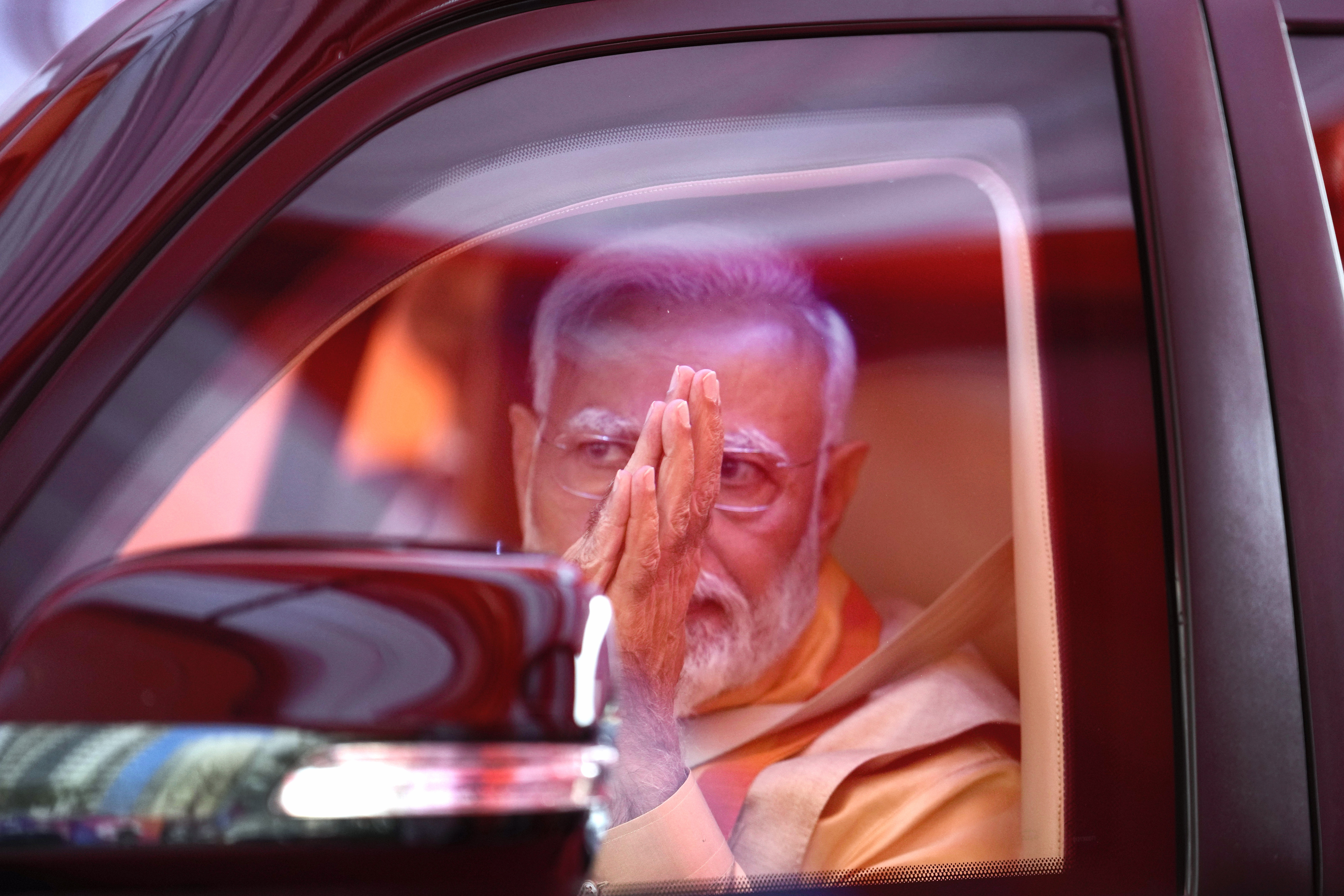 Indian Prime Minister Narendra Modi greets as he returns back after ground breaking ceremony 4.0 of global investors summit in Lucknow, capital of northern Indian state of Uttar Pradesh, Monday, Feb.. 19, 2024. (AP Photo/Rajesh Kumar Singh)