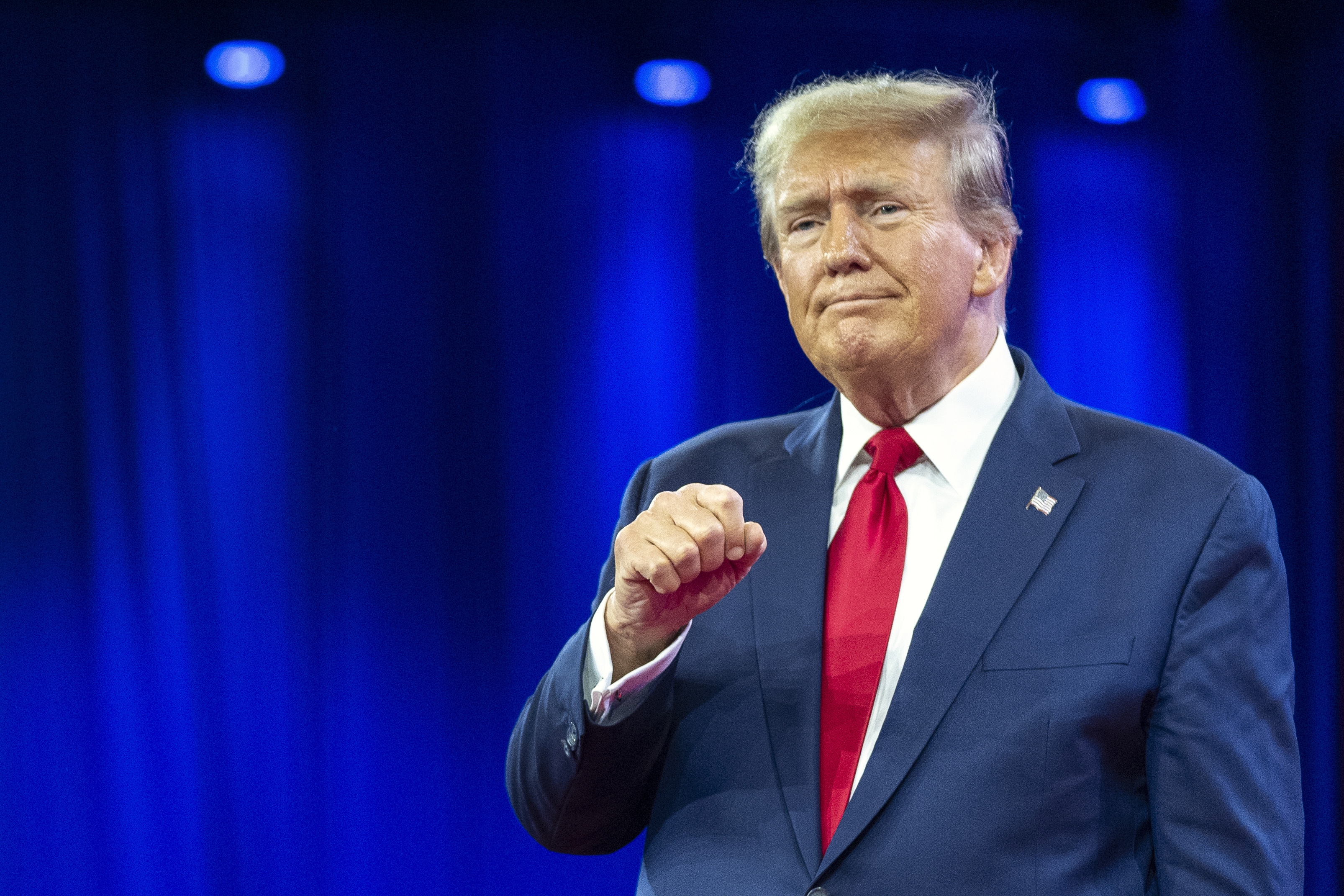 Republican presidential candidate former President Donald Trump pumps his fist as he departs after speaking during the Conservative Political Action Conference on February 24, 2024