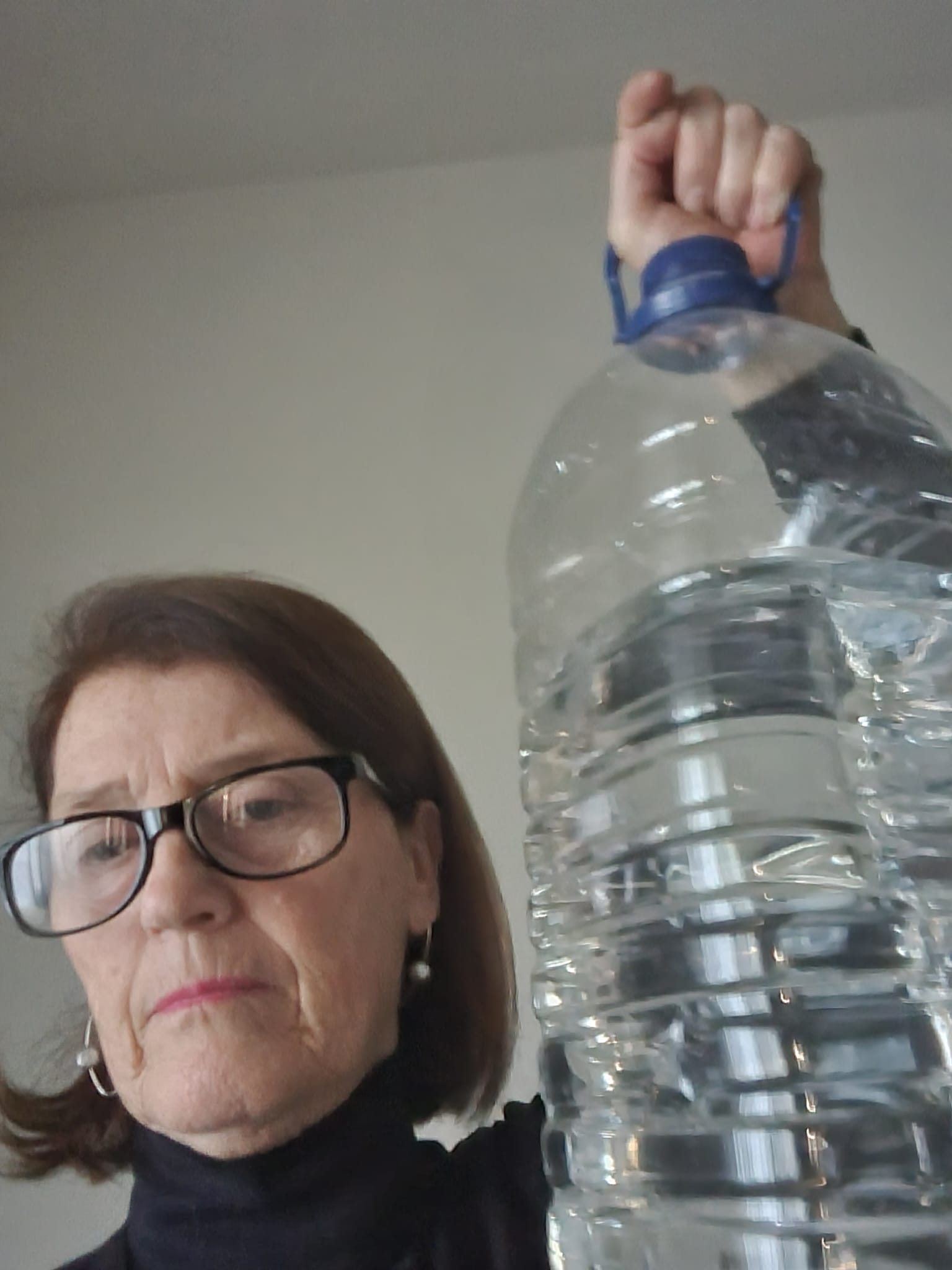 Ana Miquel, a retired hotel executive from Barcelona, collects water in her kitchen [Courtesy: Ana Miquel]