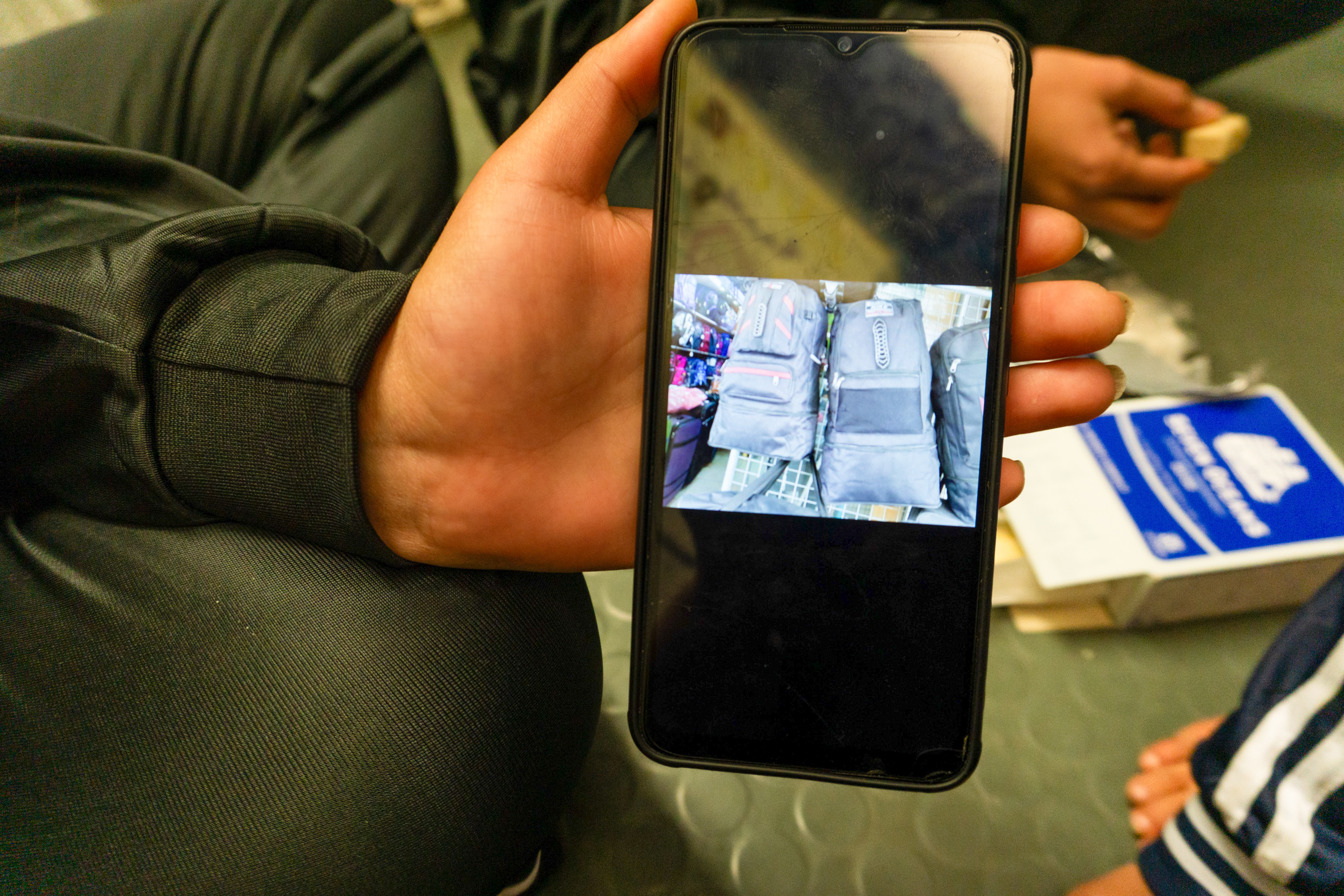 Linda showing their bags that never made it across the sea Women, Humanity 1 [Nora Adin Fares/Al Jazeera]