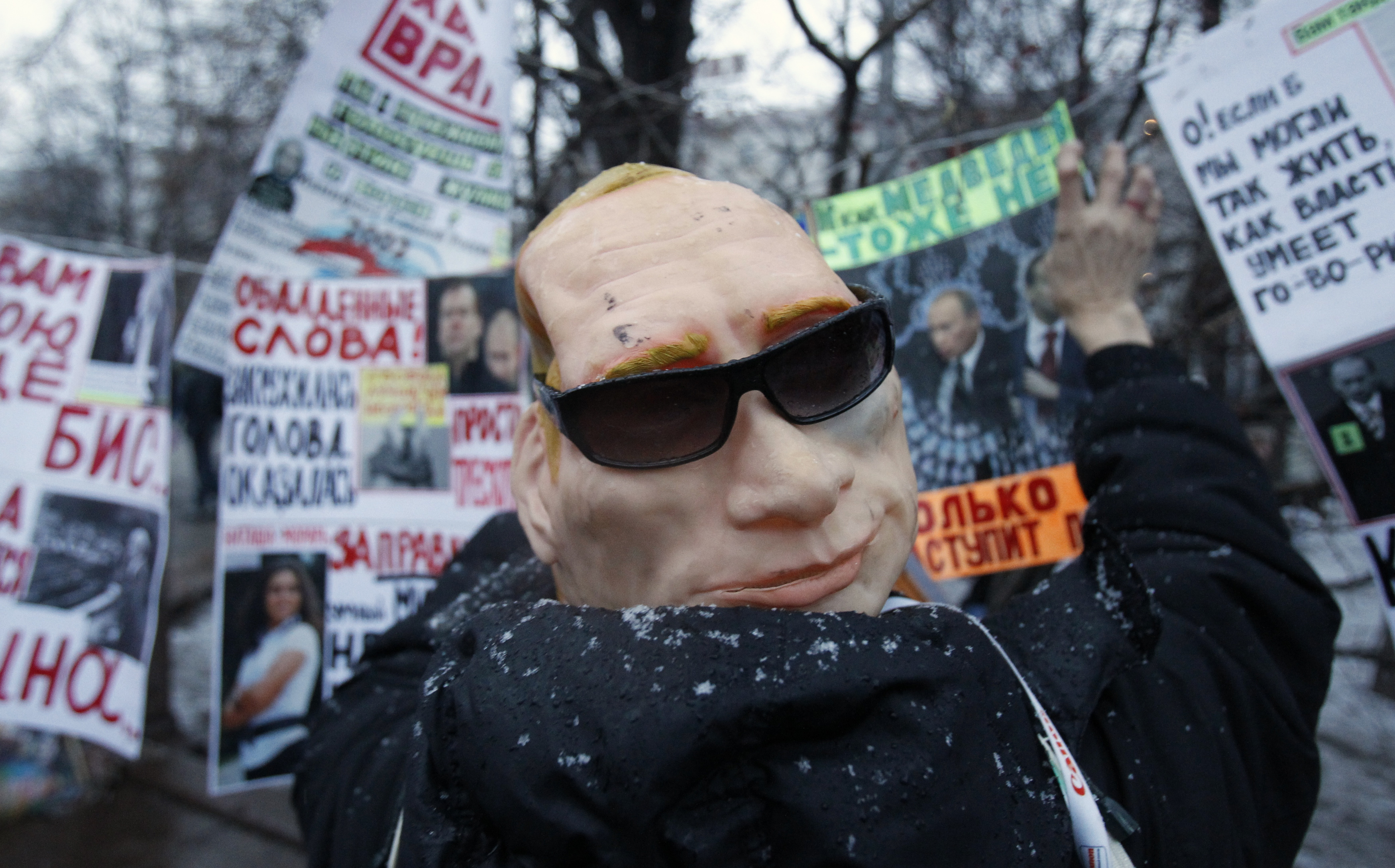 A protester, who is wearing a mask of Russia's Prime Minister Vladimir Putin, attends a sanctioned rally in Bolotnaya square to protest against violations at the parliamentary elections in Moscow December 10, 2011. Tens of thousands of protesters took to the streets of cities across Russia on Saturday to demand an end to Vladimir Putin's rule and complain about alleged election fraud in the biggest show of defiance since he took power more than a decade ago. REUTERS/Sergei Karpukhin (RUSSIA - Tags: POLITICS ELECTIONS CIVIL UNREST)