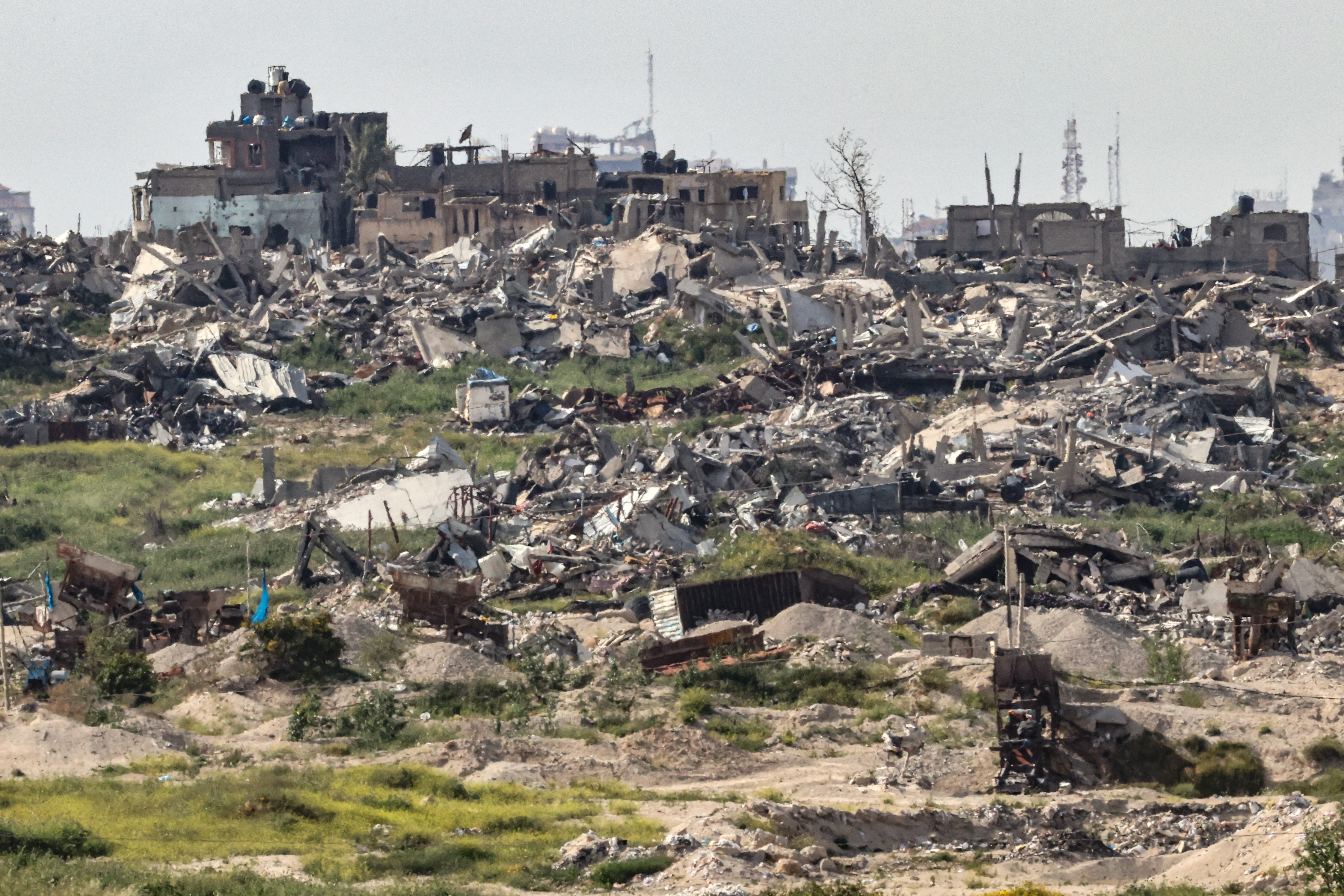 This picture taken from Israel's southern border with the Gaza Strip shows buildings previously destroyed by Israeli strikes