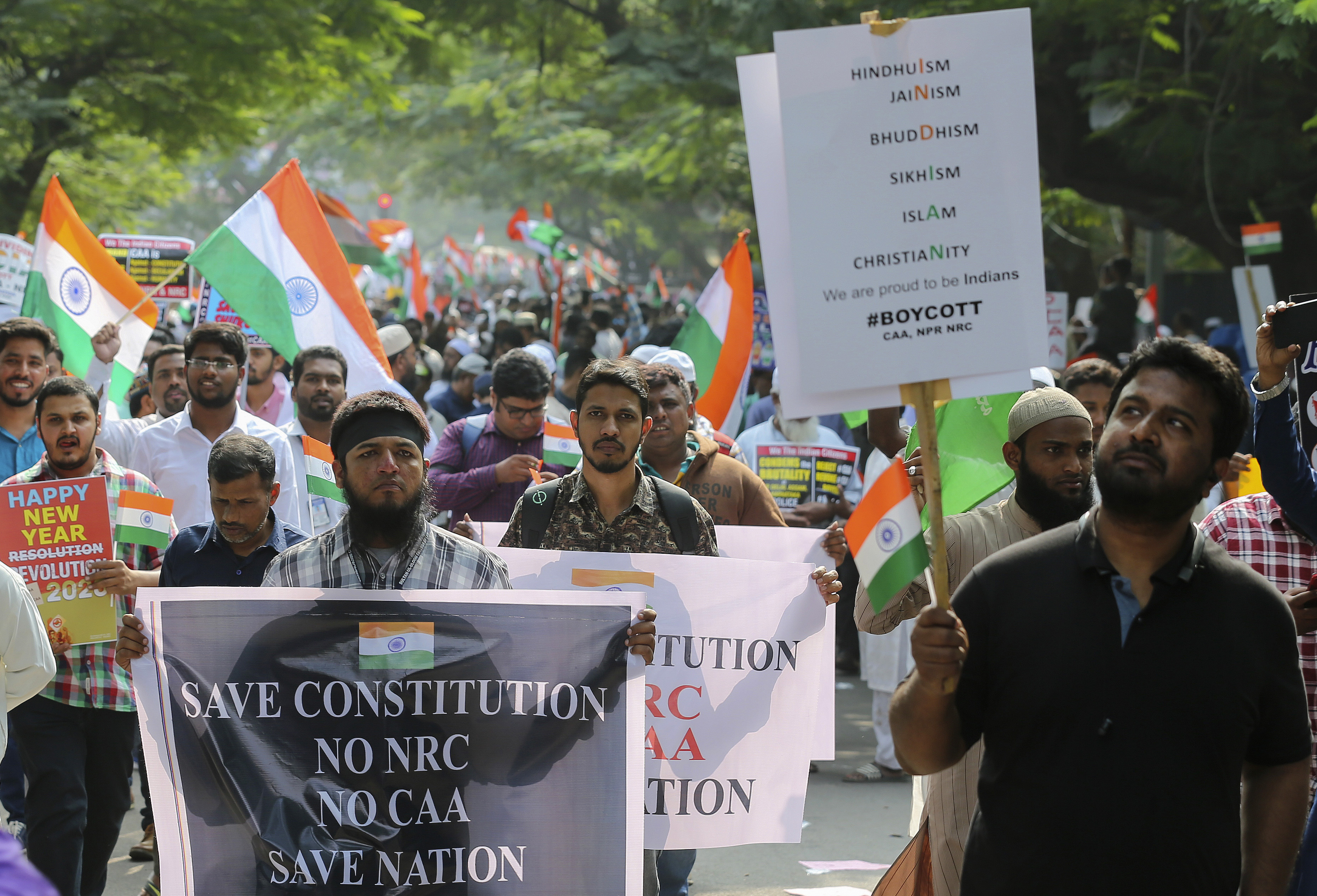Indians hold placards as they march during a protest against a new citizenship law that opponents say threatens India's secular identity in Hyderabad, India, Saturday, Jan. 4, 2020. The new citizenship law and a proposed National Register of Citizens have brought thousands of protesters out in the streets in many cities and towns since Parliament approved the measure on Dec. 11, leaving at least 23 dead in clashes between security forces and the protesters. (AP Photo/Mahesh Kumar A.)