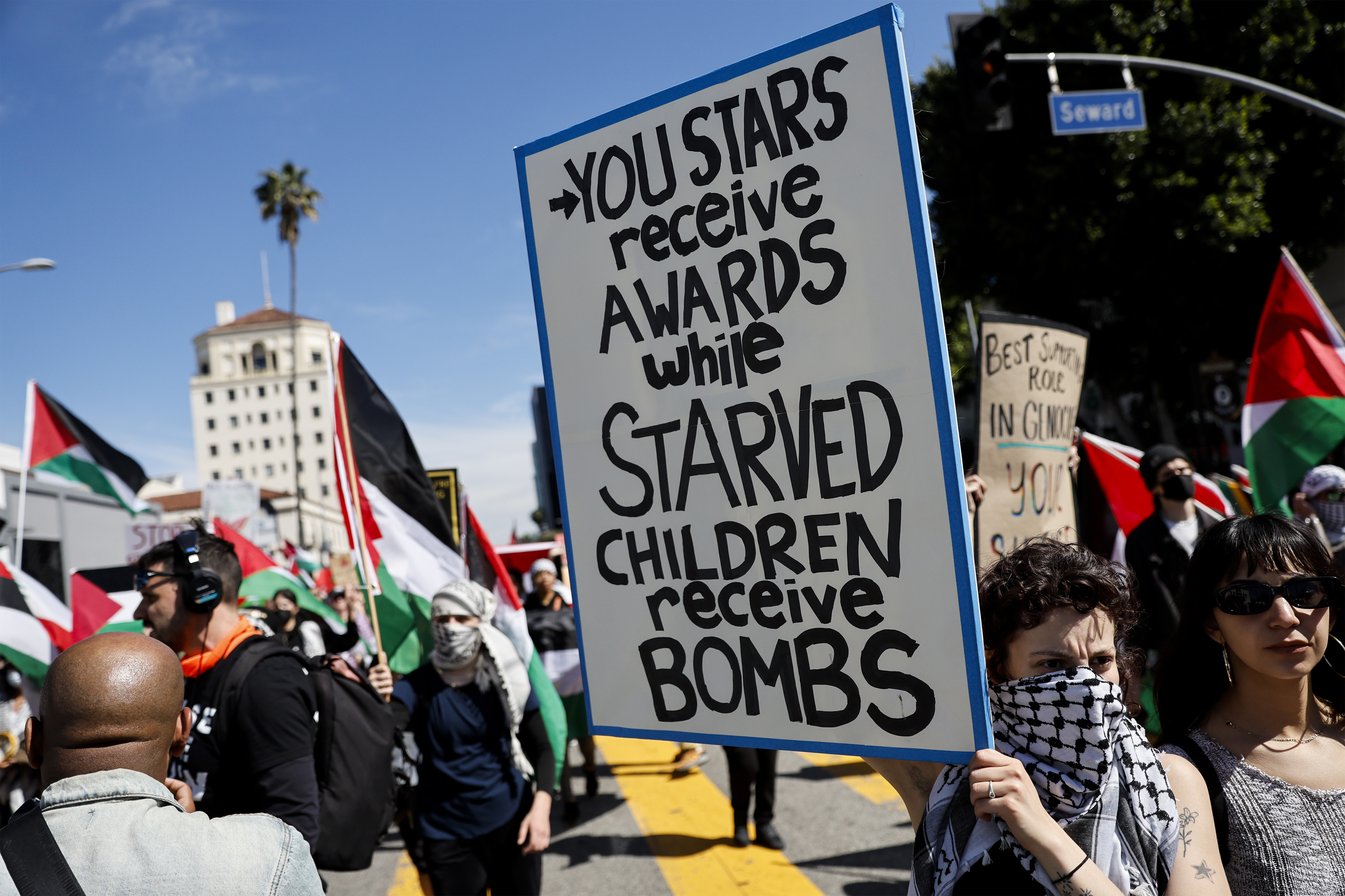 A protester holds a poster during a demonstration in support of Palestinians calling for a ceasefire in Gaza
