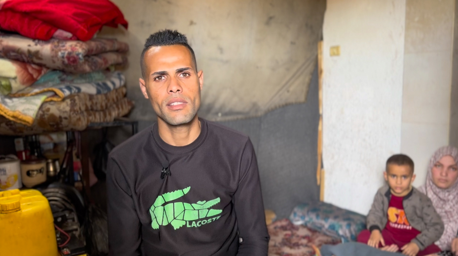 Yazan's father speaks in their small shelter