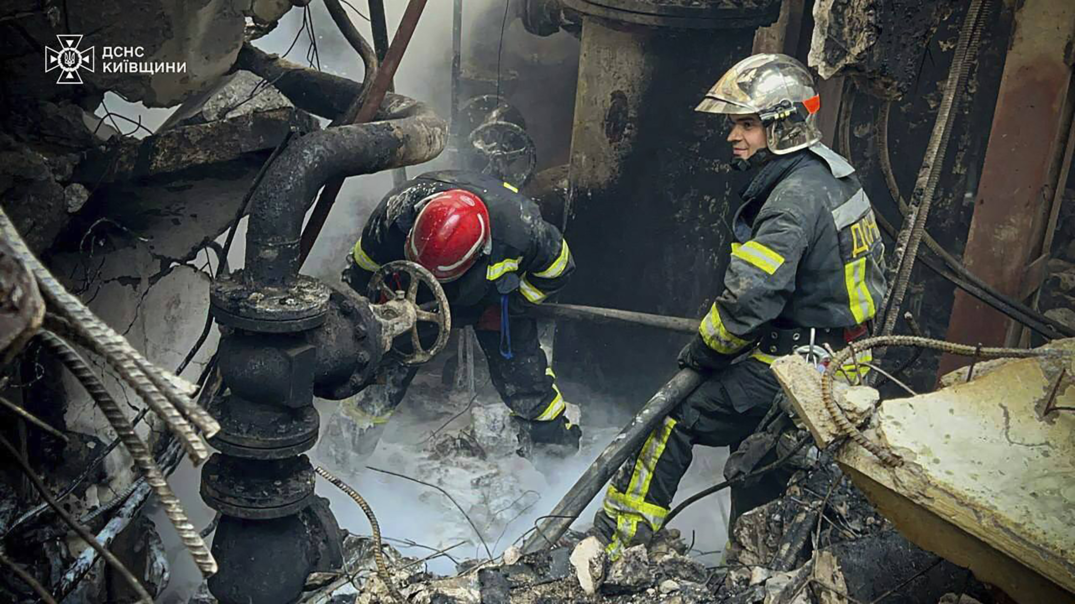 In this photo provided by the Ukrainian Emergency Service, emergency workers extinguish a fire after a Russian attack on the Trypilska thermal power plant in Ukrainka, Kyiv region, Ukraine