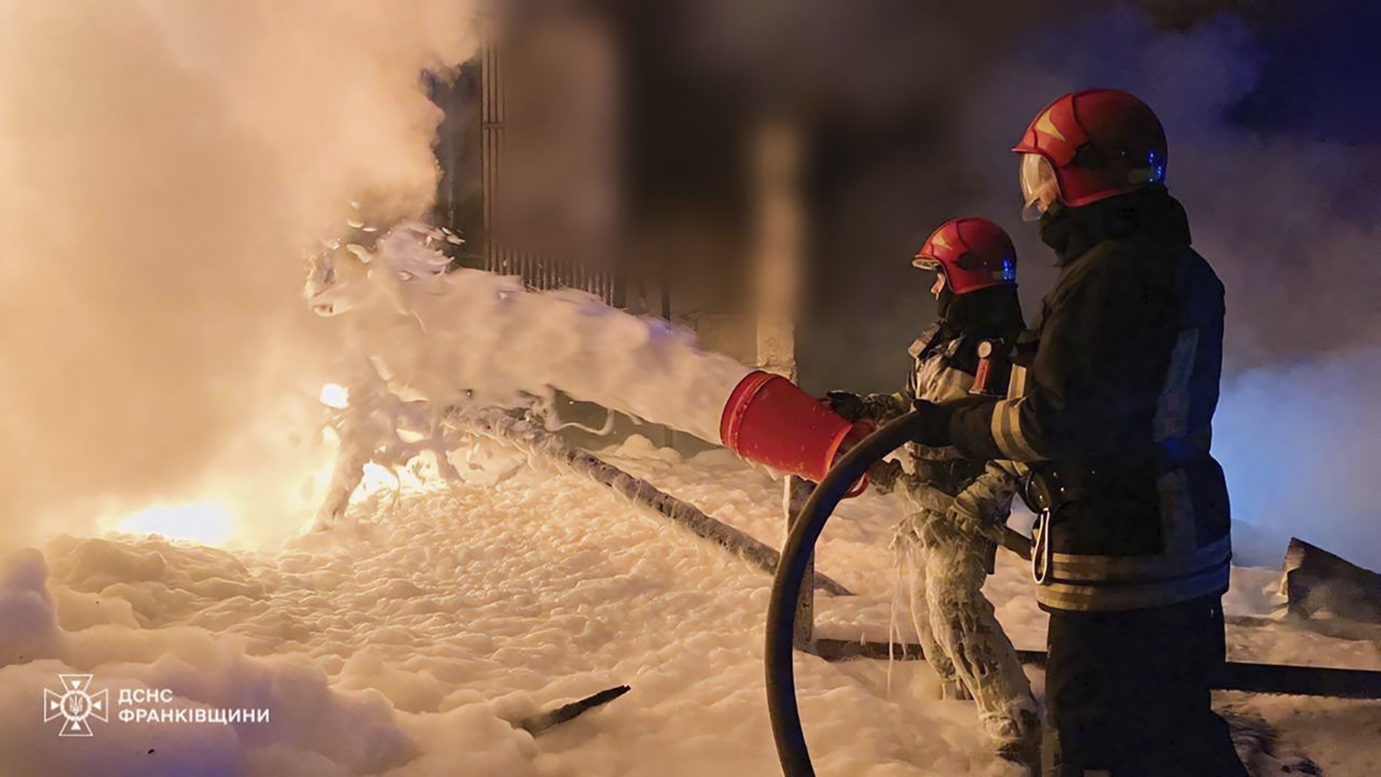 Emergency services personnel work to extinguish a fire