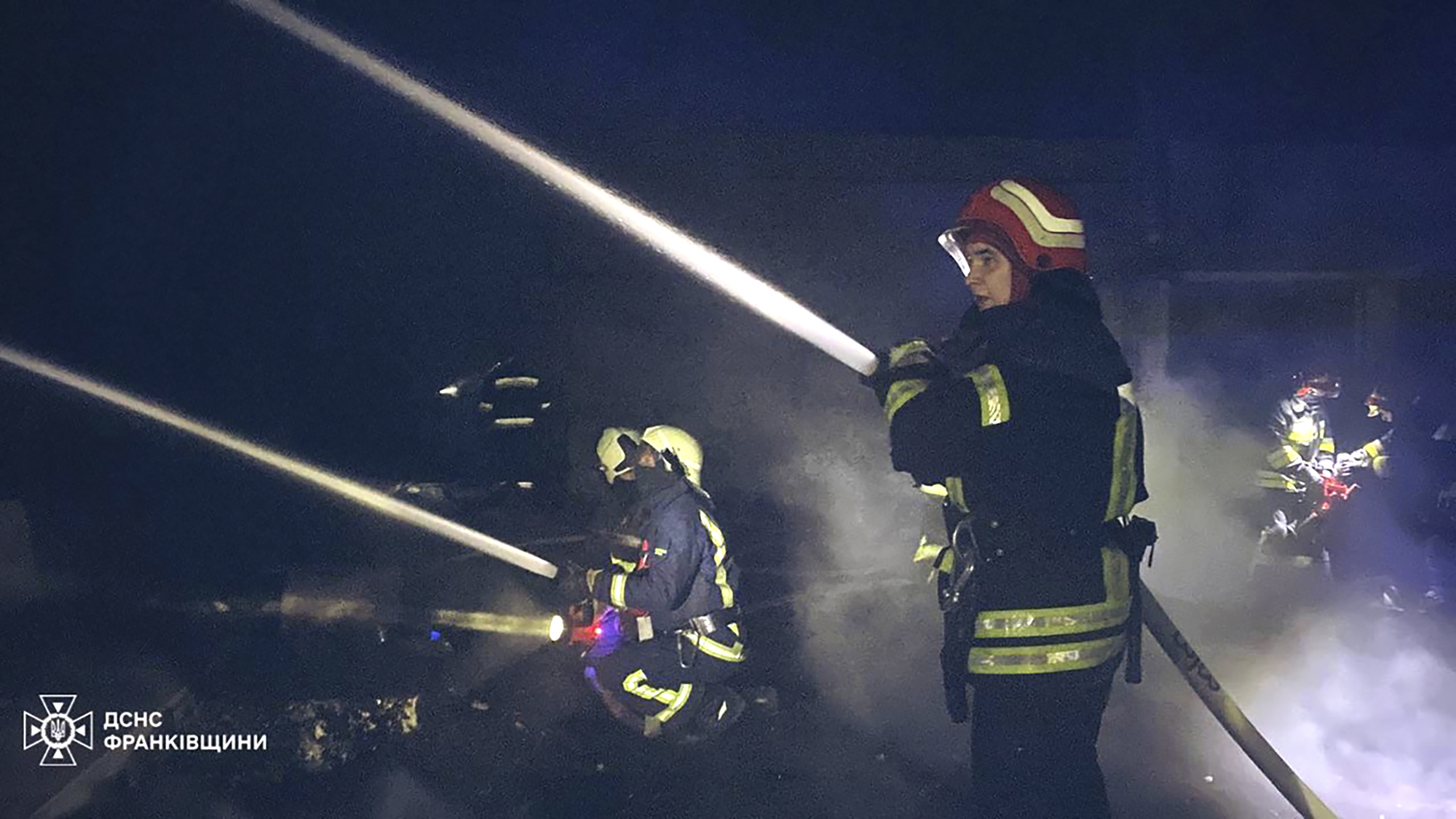 Emergency services personnel work to extinguish a fire in the Ivano-Frankivsk region, Ukraine