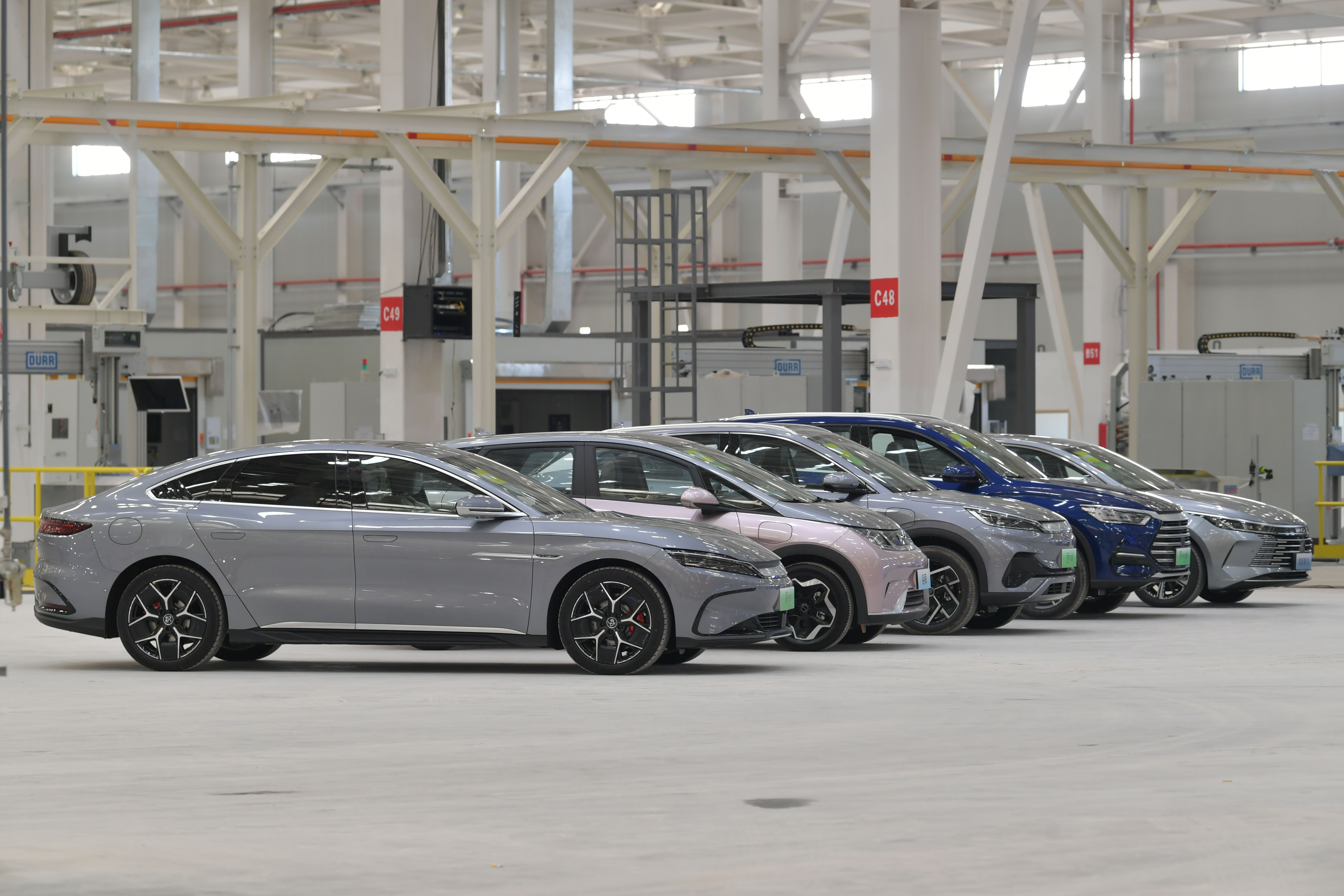 (L-R) A Han EV electric sedan, a Dolphin all-electric subcompact hatchback, a Yuan Plus all-electric small SUV, a Song Plus DM-i SUV and a Destroyer 05 compact sedan are on display at BYD’s new manufacturing base on June 30, 2022, in Changfeng County, Hefei City, Anhui province of China [VCG via Getty Images]