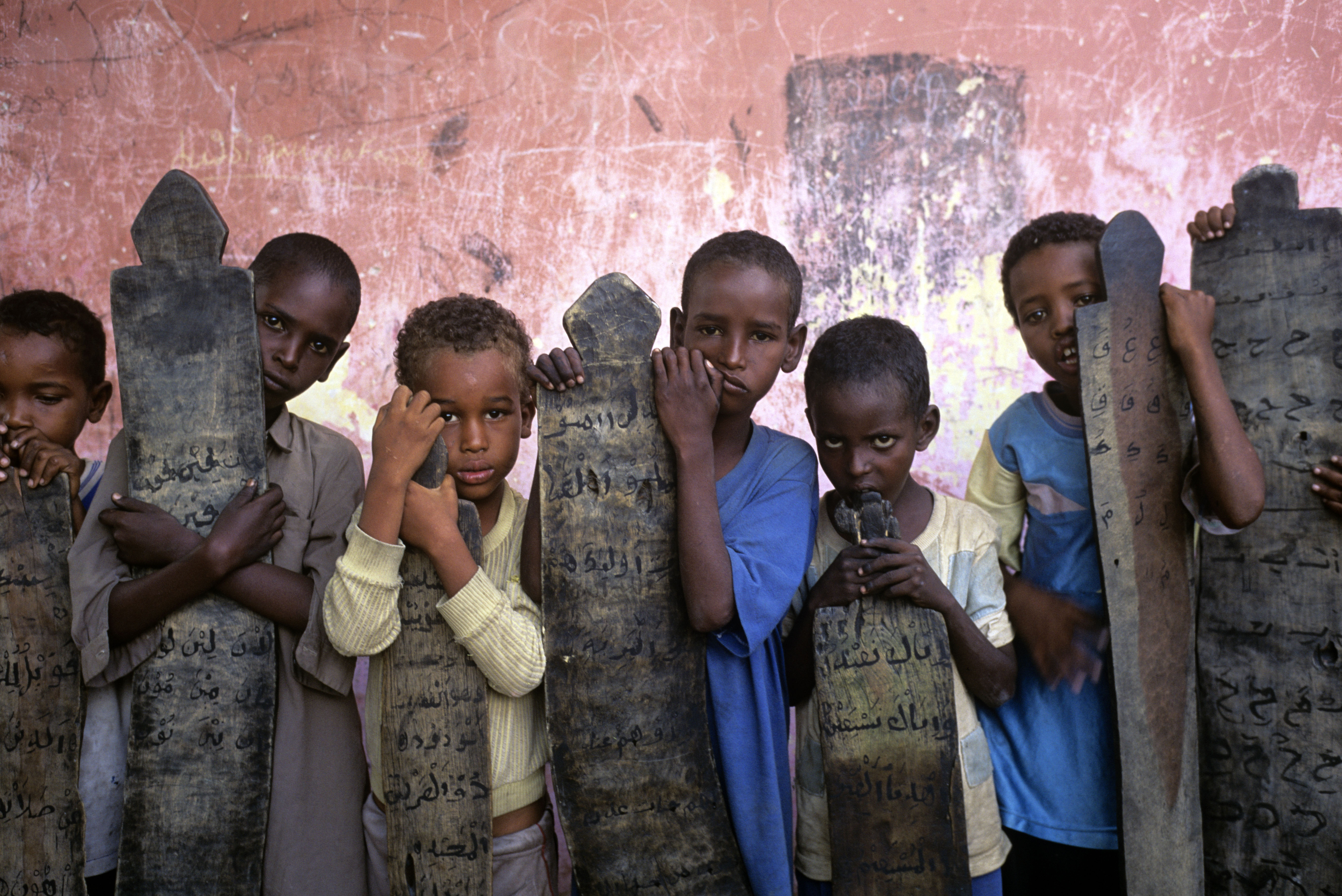 Rwandan boys pose with gravestones to commemorate the 1994 Rwanda genocide, in which an estimated 800,000 Tutsis and moderate Hutus were massacred