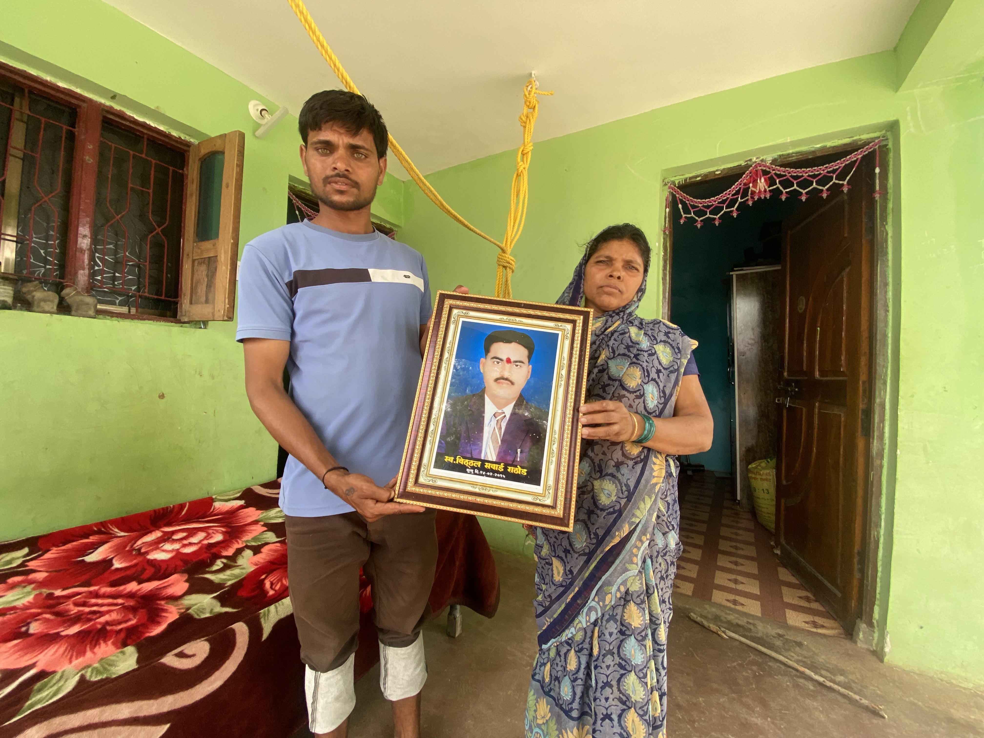 Family members of Vithal Rathod, the farmer in Dabhadi village who took his own life, stand outside their home in Yavatmal. It was in Dabhadi that Prime Minister Narendra Modi launched his farm outreach in 2014. A decade later, crosses losses, debts and deaths are mounting [Kunal Purohit/Al Jazeera]