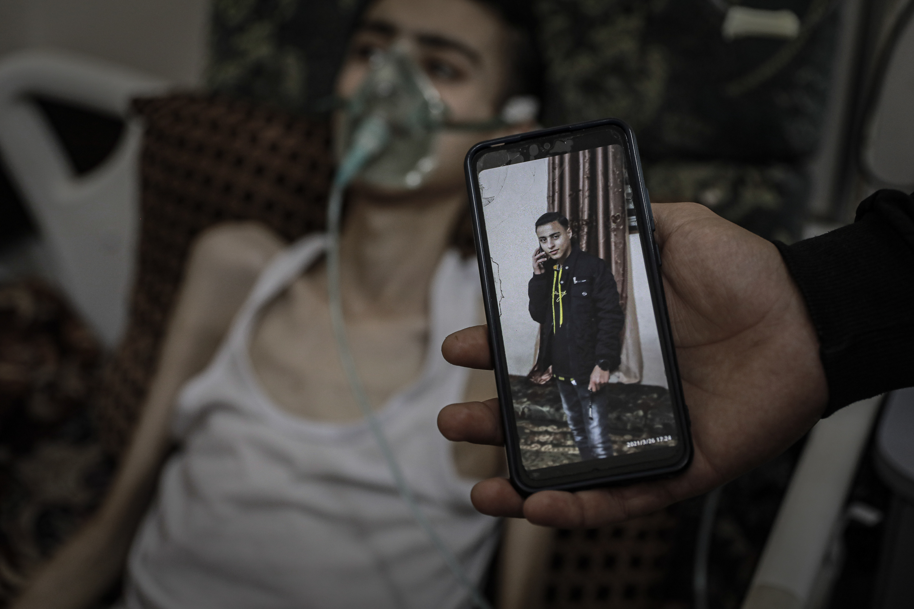 Abdul Majeed’s health deteriorated drastically during the war. Here, a photo of him in healthier times is held up to compare with his current state