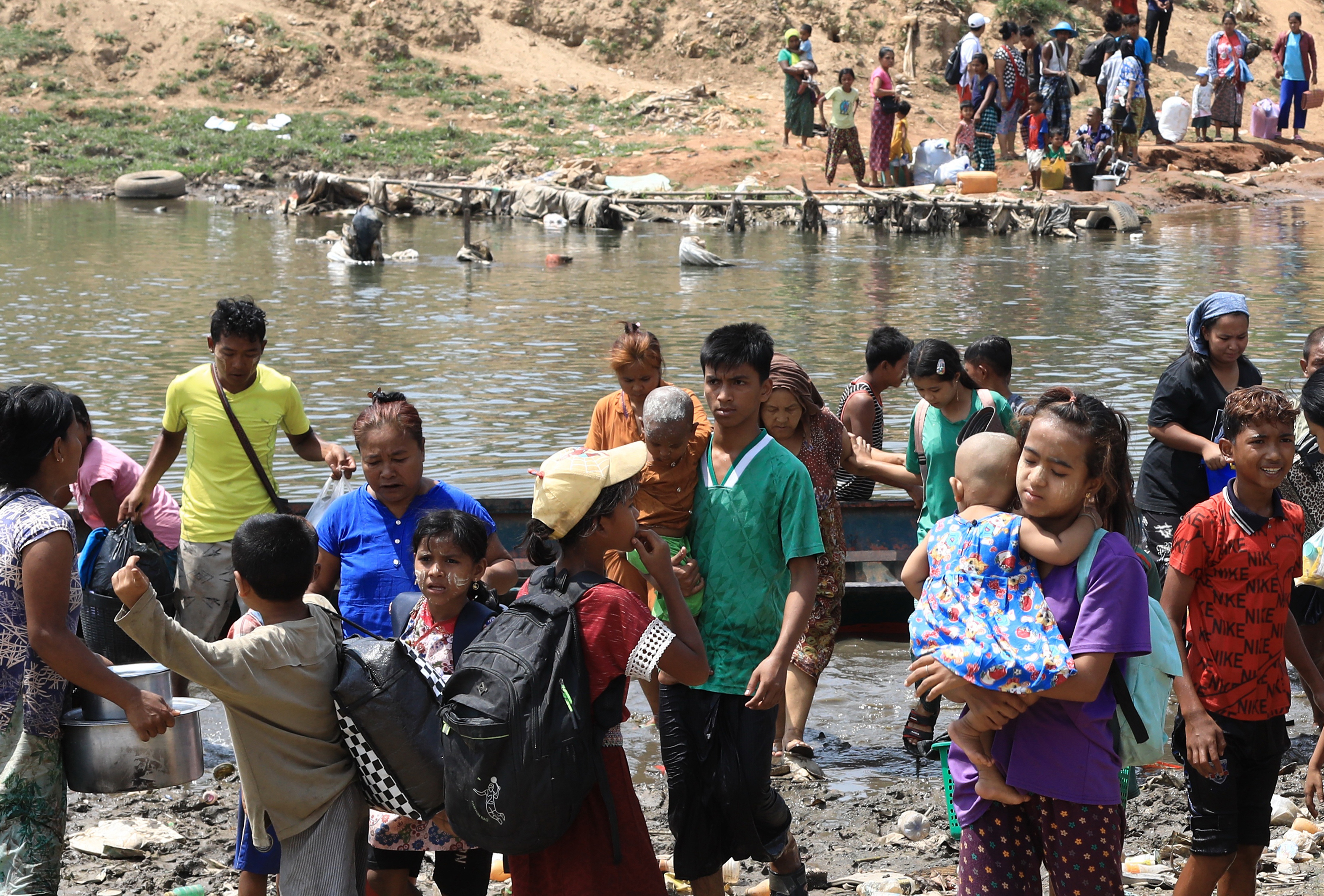 Myanmar villagers crossing the river into Thailand.