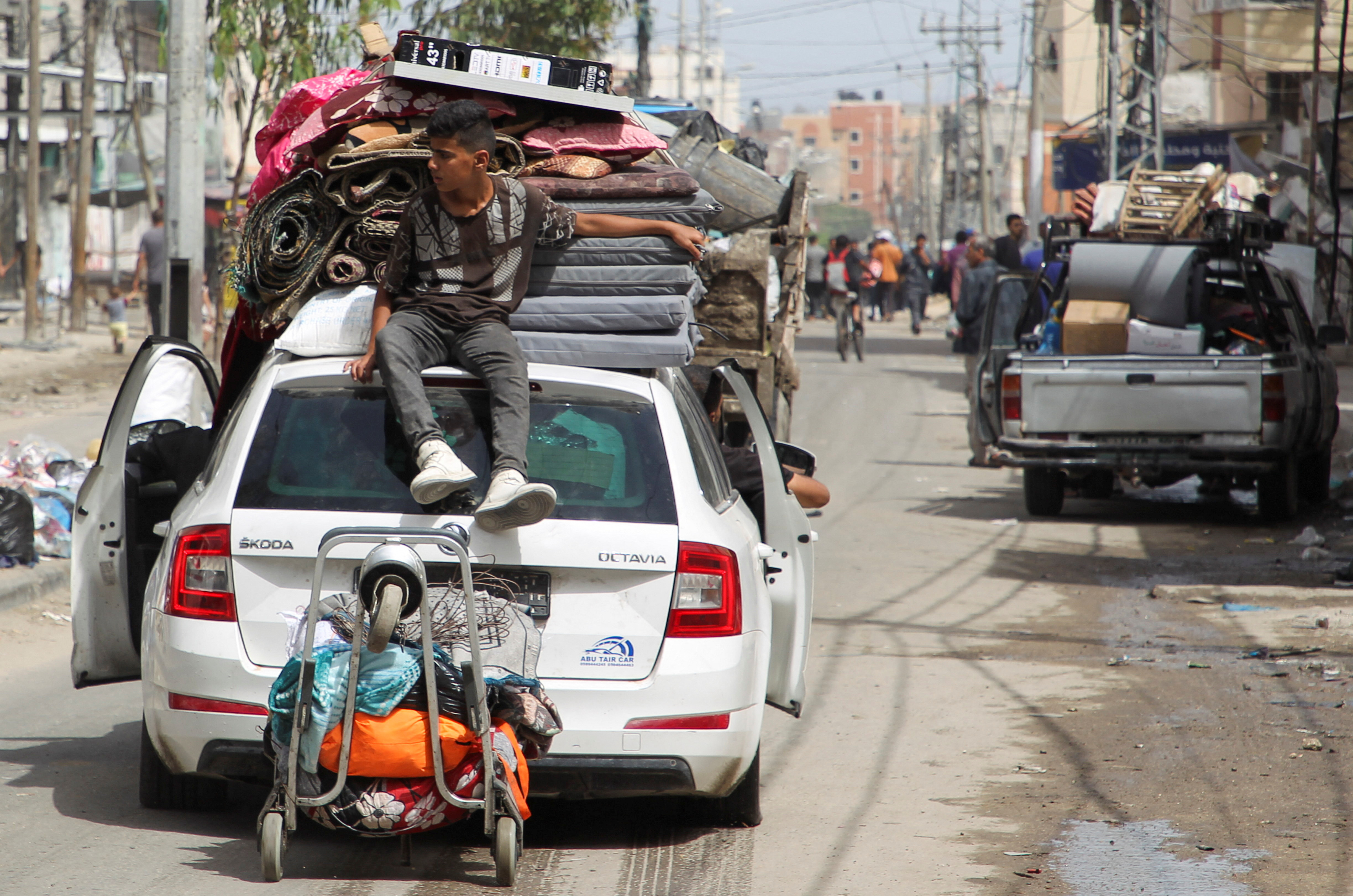 A person sits atop a vehicle loaded with belongings, as Palestinians prepare to evacuate, after Israeli forces launched a ground and air operation in the eastern part of Rafah, amid the ongoing conflict between Israel and Hamas, in Rafah, in the southern Gaza Strip, May 11