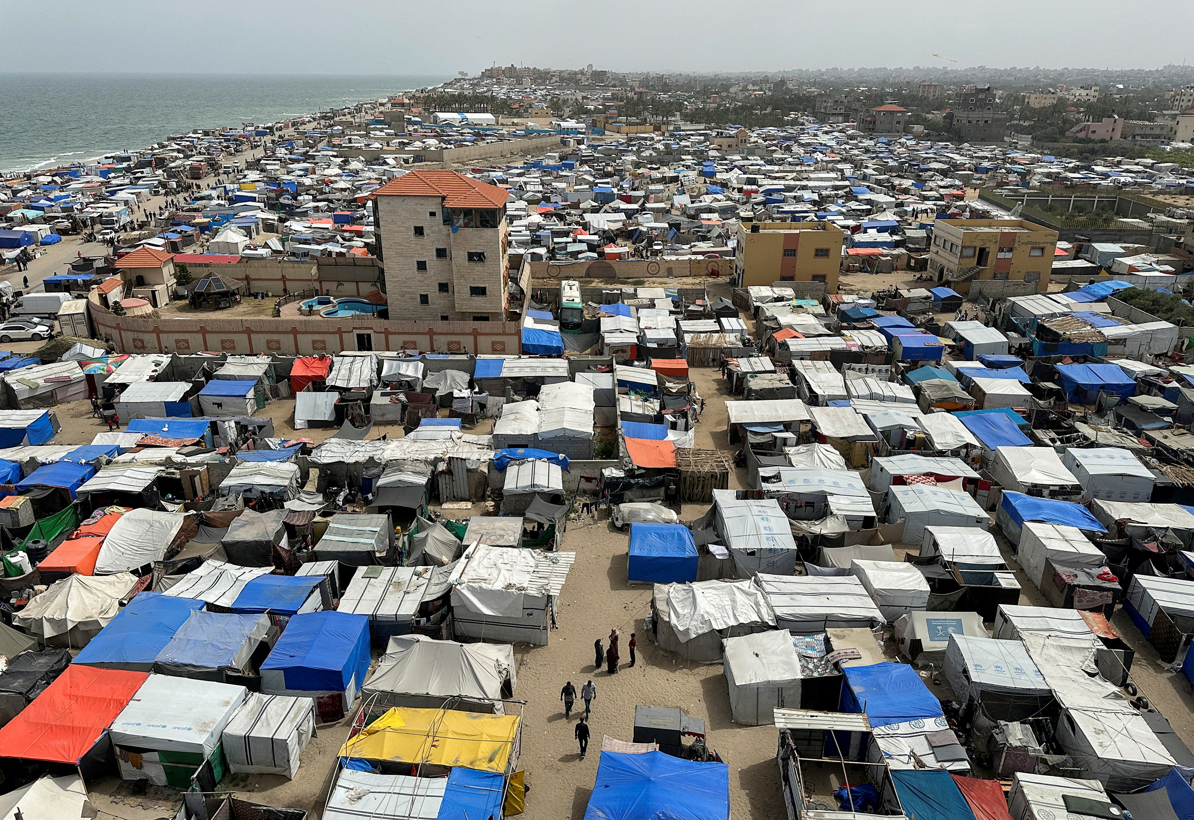 Displaced Palestinians, who fled their houses due to Israeli strikes, shelter at a tent camp, amid the ongoing conflict between Israel and the Palestinian Islamist group Hamas, in Deir Al-Balah in central Gaza Strip May 11