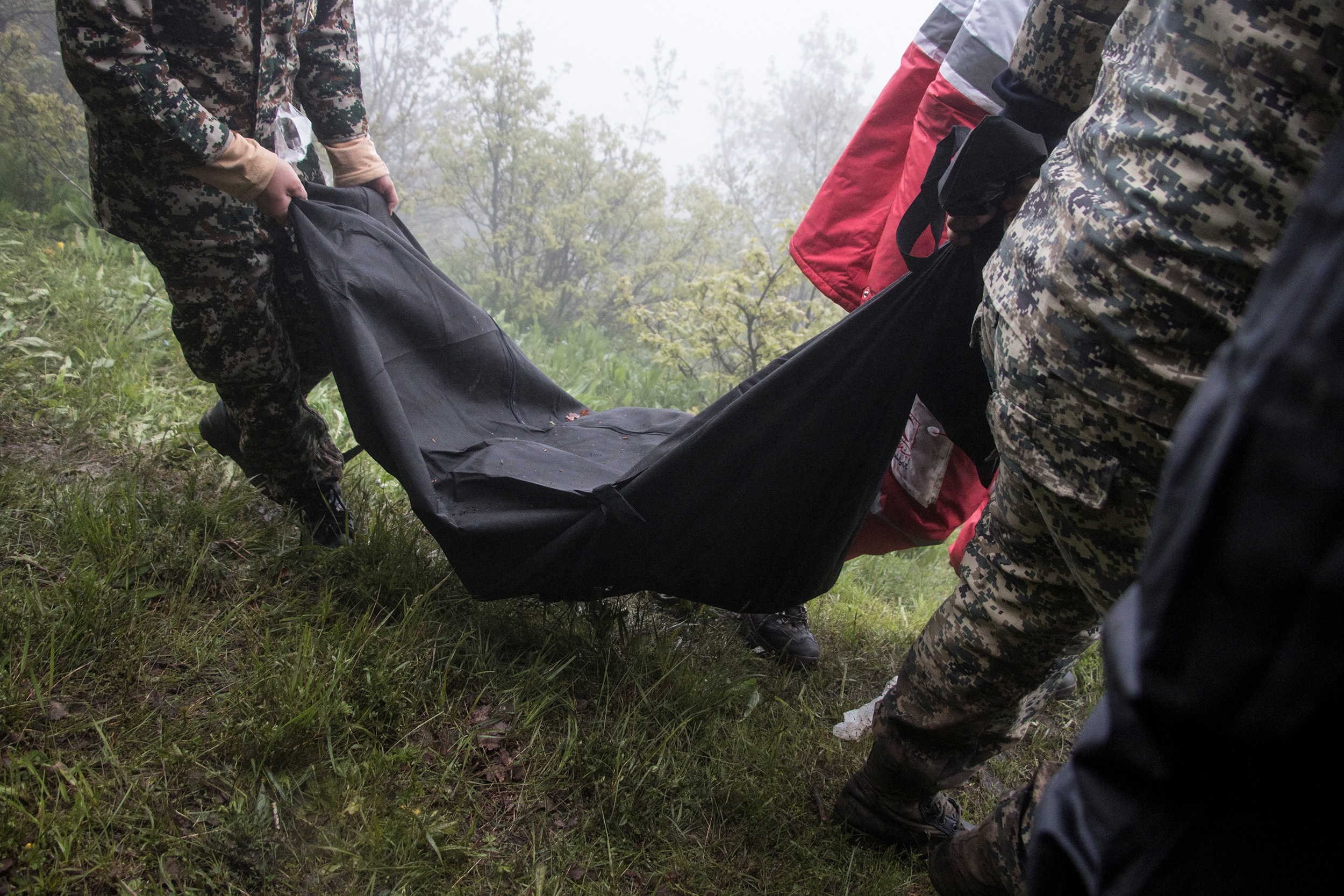 Rescue team carry a body
