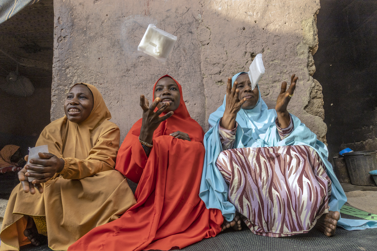 'Some girls couldn't attend school because of their periods but we got sanitary pads at school, which was a big deal'. Rahamatu, 19, (centre) with her mother, ‘Mama’ Sakina, (left) and her grandmother, ‘Kaka’, 58, (right), at home in Bauchi, Nigeria