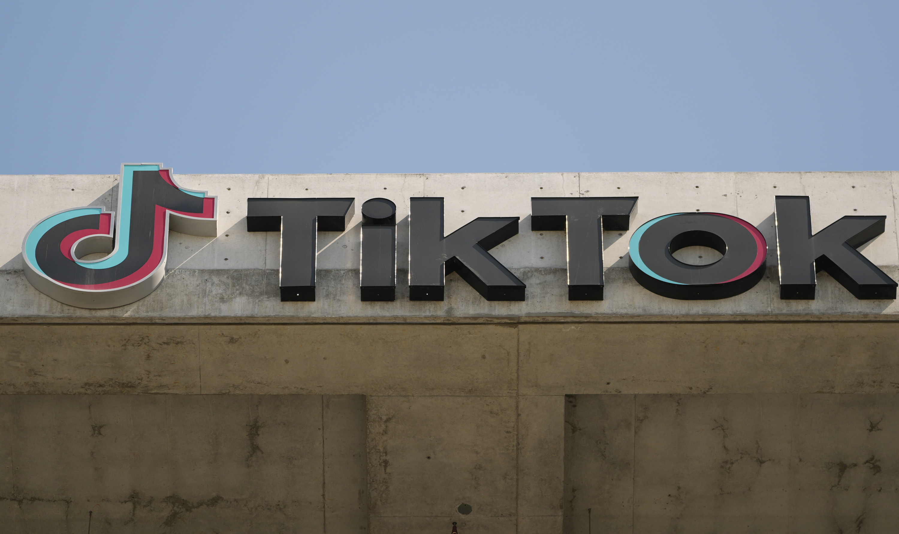 An image of the TikTok logo atop a building.