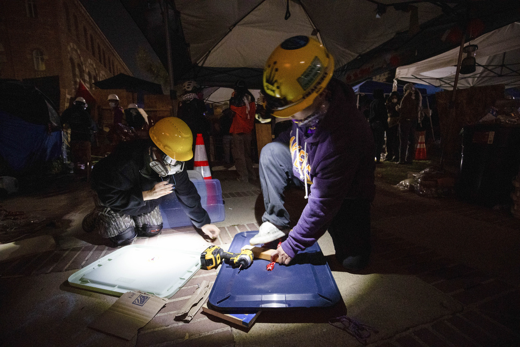 Pro-Palestinian demonstrators build makeshift shields in preparation for the possible clearing of an encampment by authorities on the UCLA campus Wednesday, May 1, 2024
