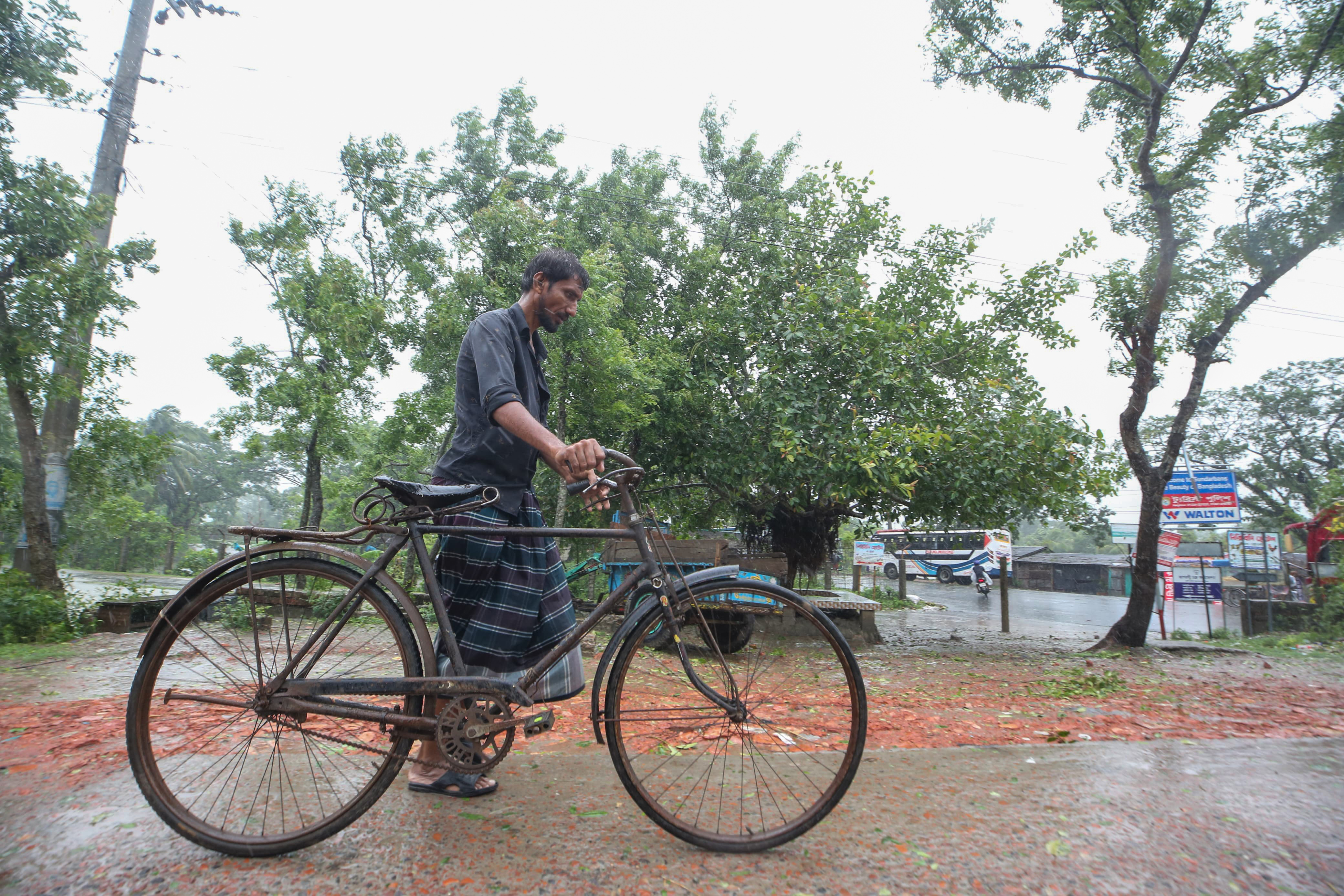 Cyclone blows away thatched roofs and cuts power in Bangladesh and India