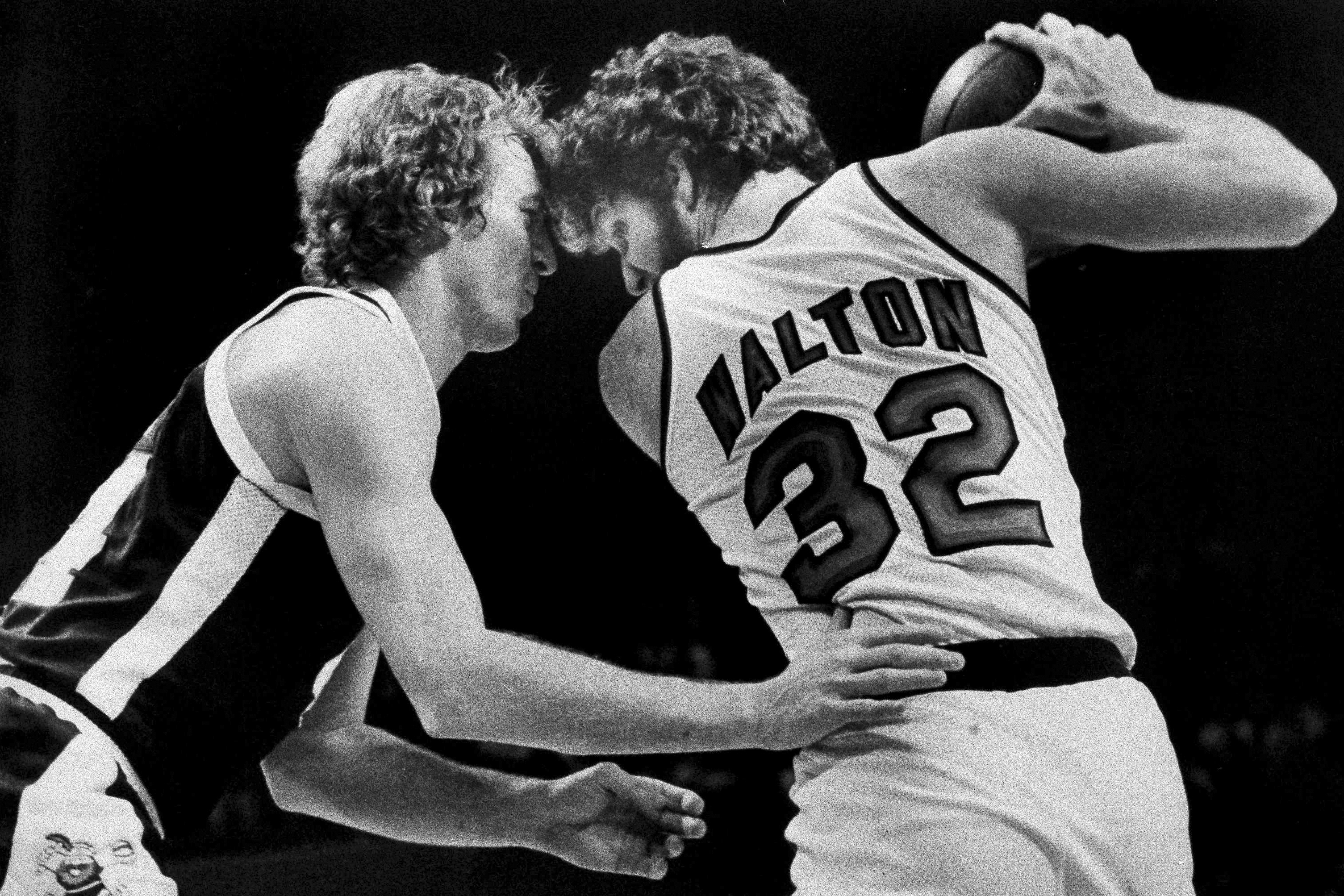 The Denver Nuggets’ Dan Issel, left, guards Portland Trail Blazers’ Bill Walton as Walton moves towards the basket during a game in 1978