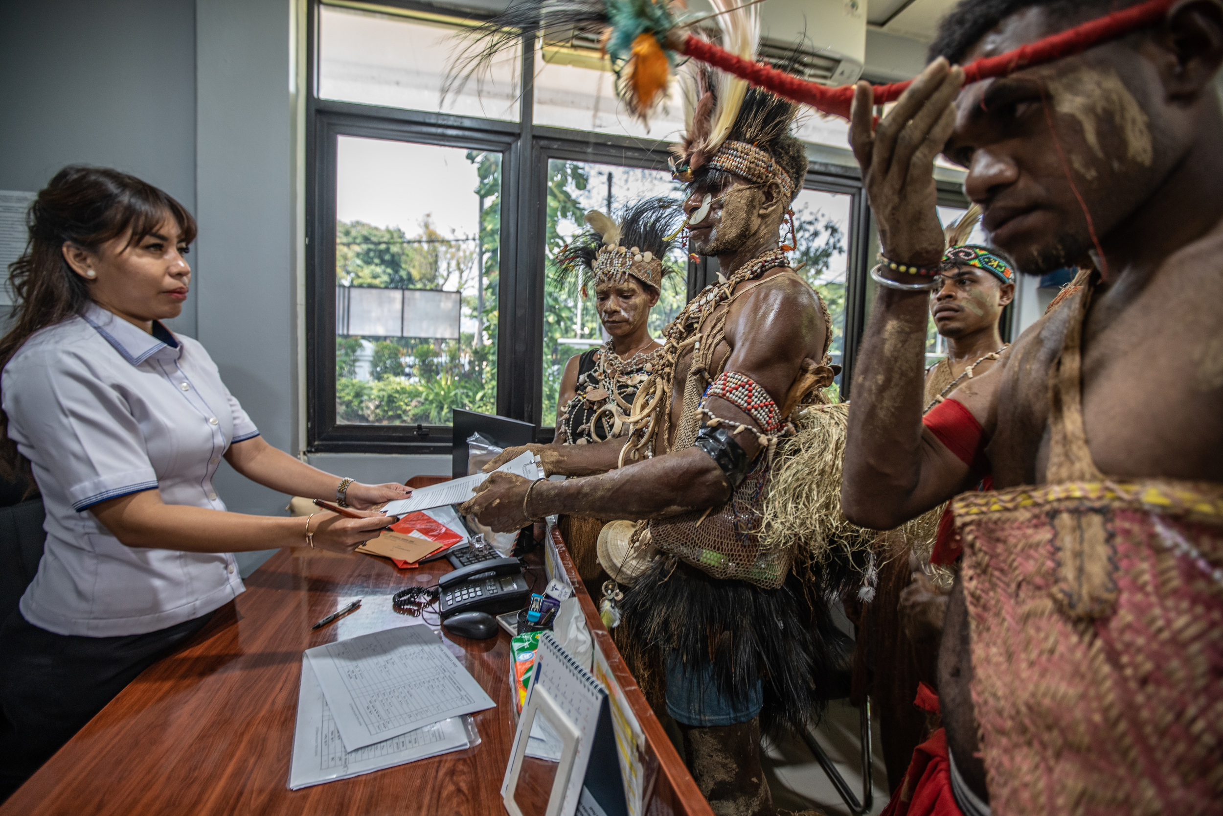 Indigenous representatives handing a letter to a court official.