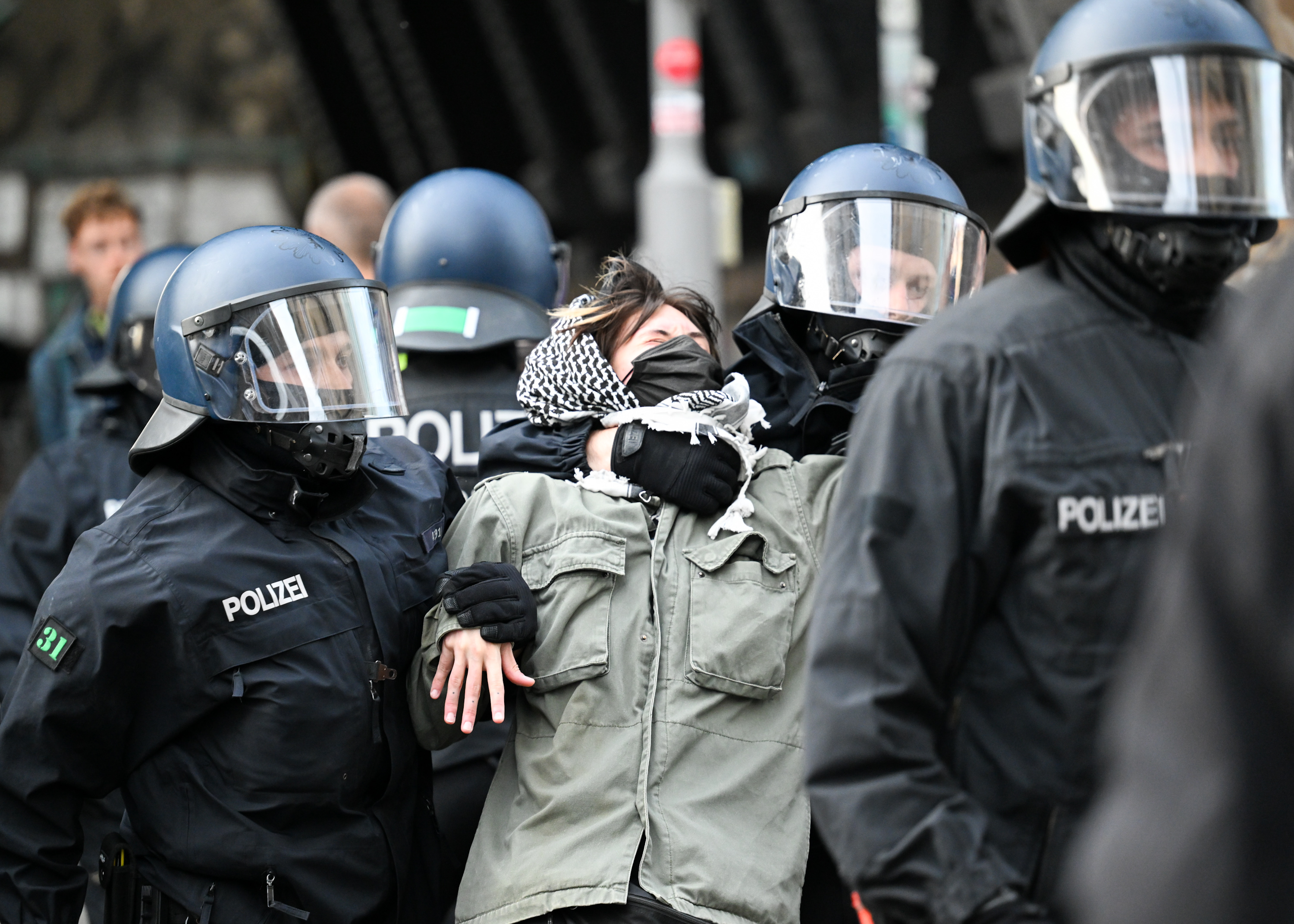 23 May 2024, Berlin: One of the pro-Palestinian occupiers of the Institute for Social Sciences at Berlin's Humboldt University (HU) is taken out of the building by two police officers. Activists have occupied the university in support of the Palestinians and in protest against Israel. Photo: Soeren Stache/dpa (Photo by Soeren Stache/picture alliance via Getty Images)