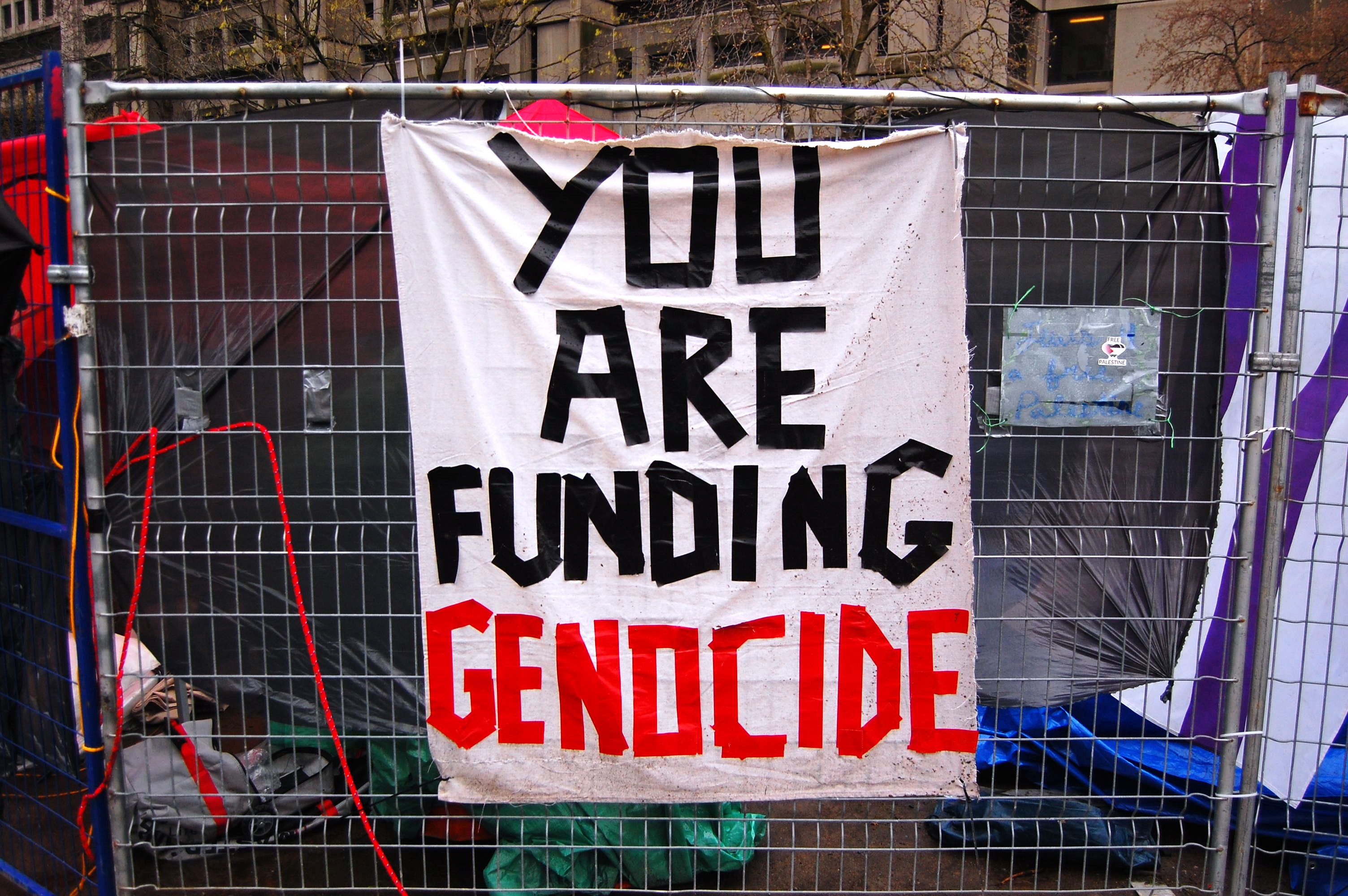 A sign reads 'You are funding genocide' at a protest camp at McGill University