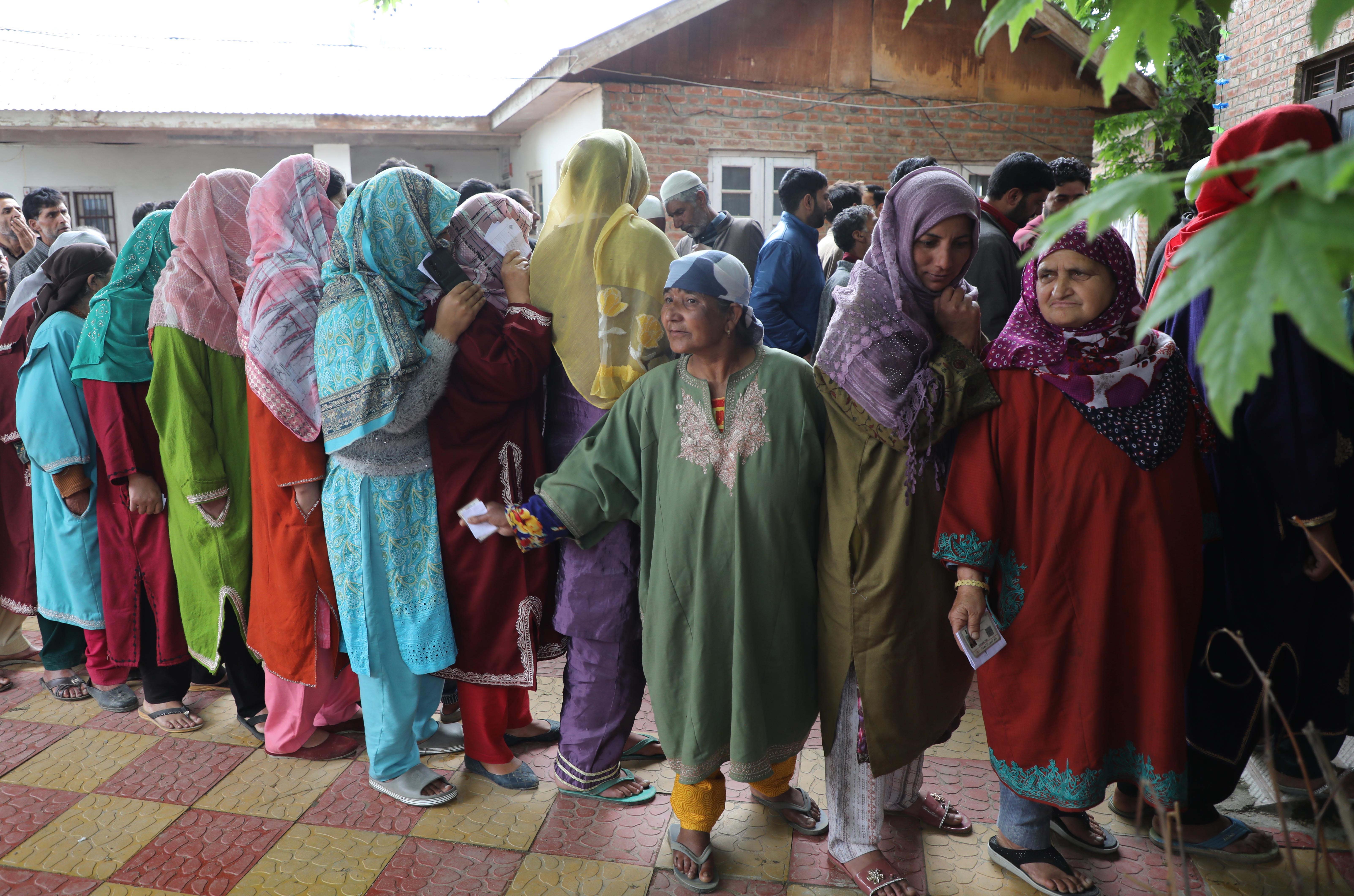 Rukhsana, third from the right, with the lavender head scarf, standing in a queue to cast her vote