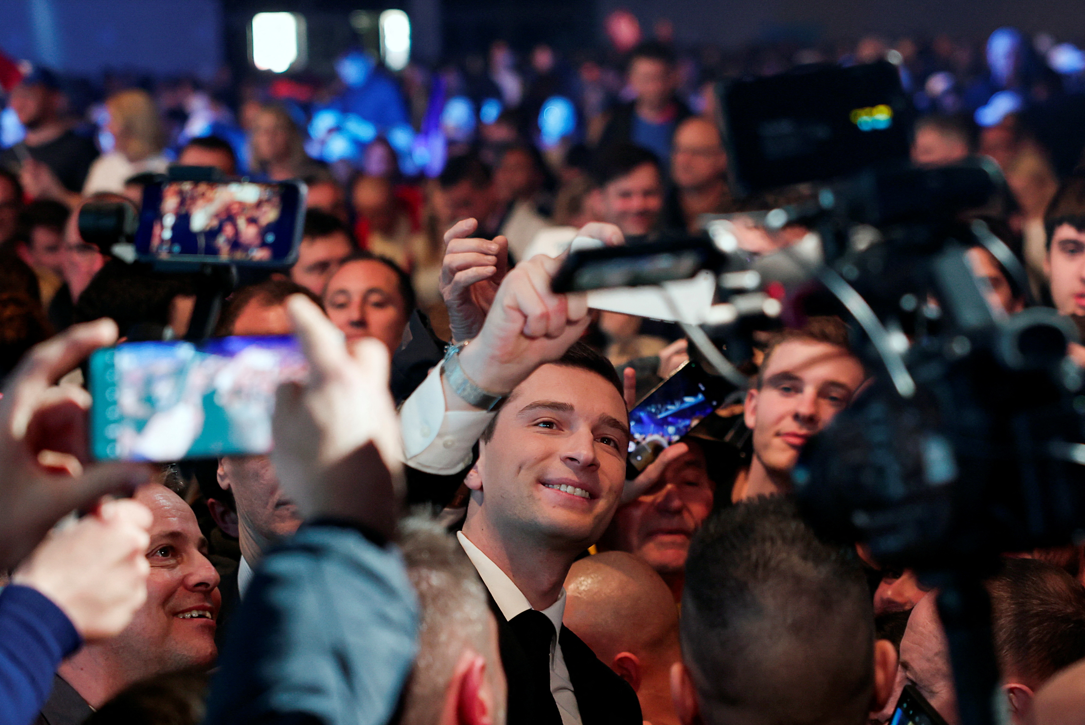 President of the French far-right National Rally (Rassemblement National-RN) party Jordan Bardella takes a selfie with supporters, during a political rally to launch the party's campaign for the European elections, in Marseille, France, on March 3, 2024 [REUTERS/Gonzalo Fuentes]