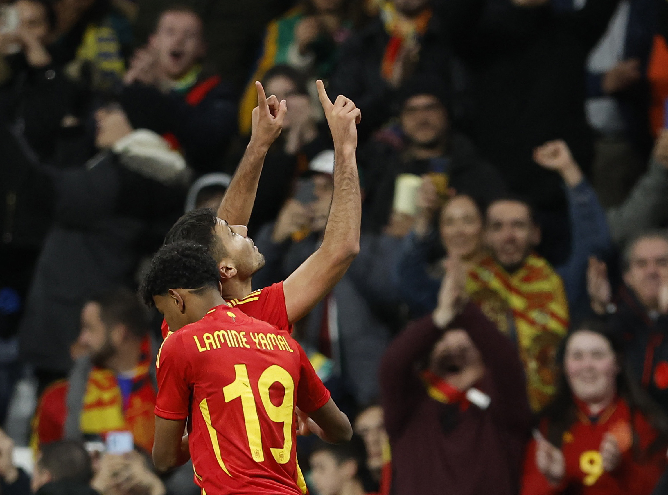 One football player hugs a second player after goal score.