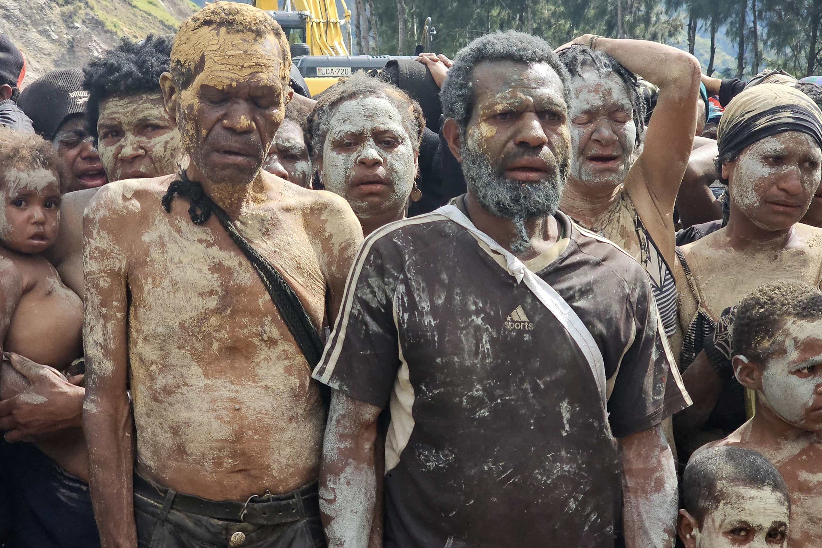 Locals react during search and rescue efforts at the site of a landslide at Yambali village in the region of Maip Mulitaka in Papua New Guinea's Enga Province on May 29
