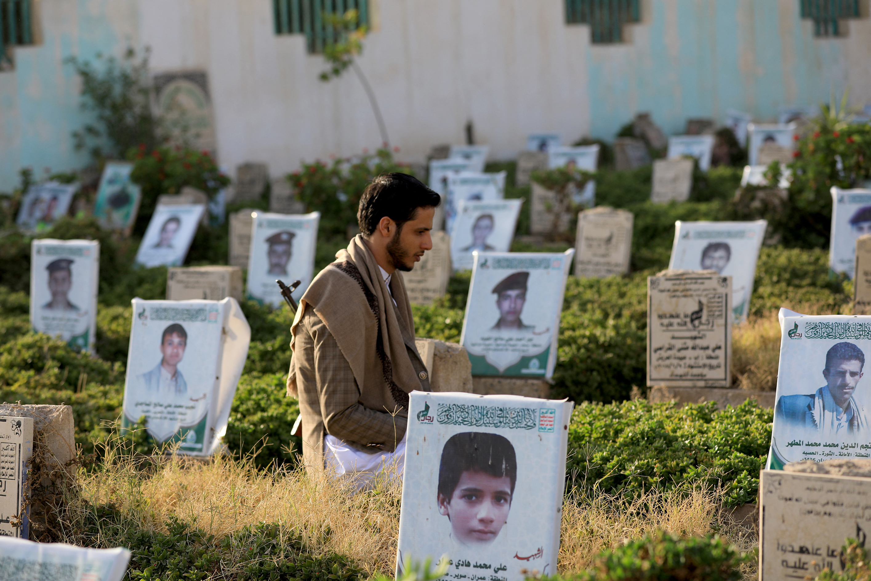 A Yemeni man kneels in prayer amid tombs on the first day of the Eid al-Adha holiday marking the end of the hajj pilgrimage to Mecca, on June 16