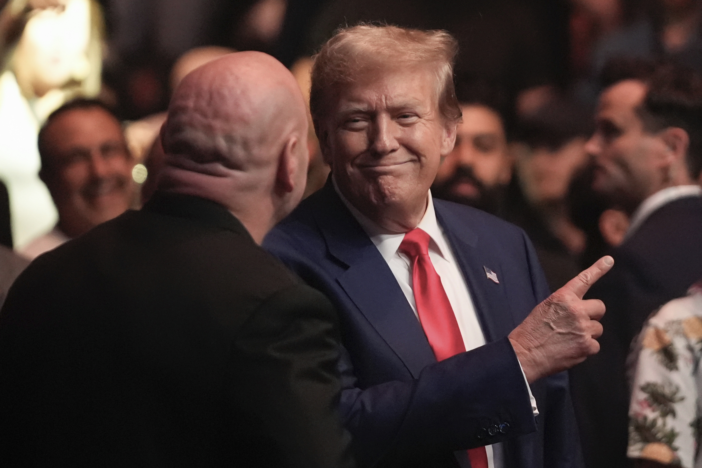 trump in suit pointing