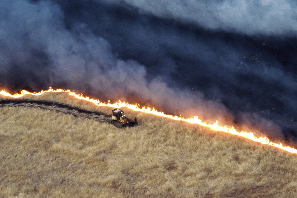 A bulldozer works against the Corral Fire on Sunday, June 2, 2024, near Tracy, California, the US [California Department of Forestry and Fire Protection via AP]