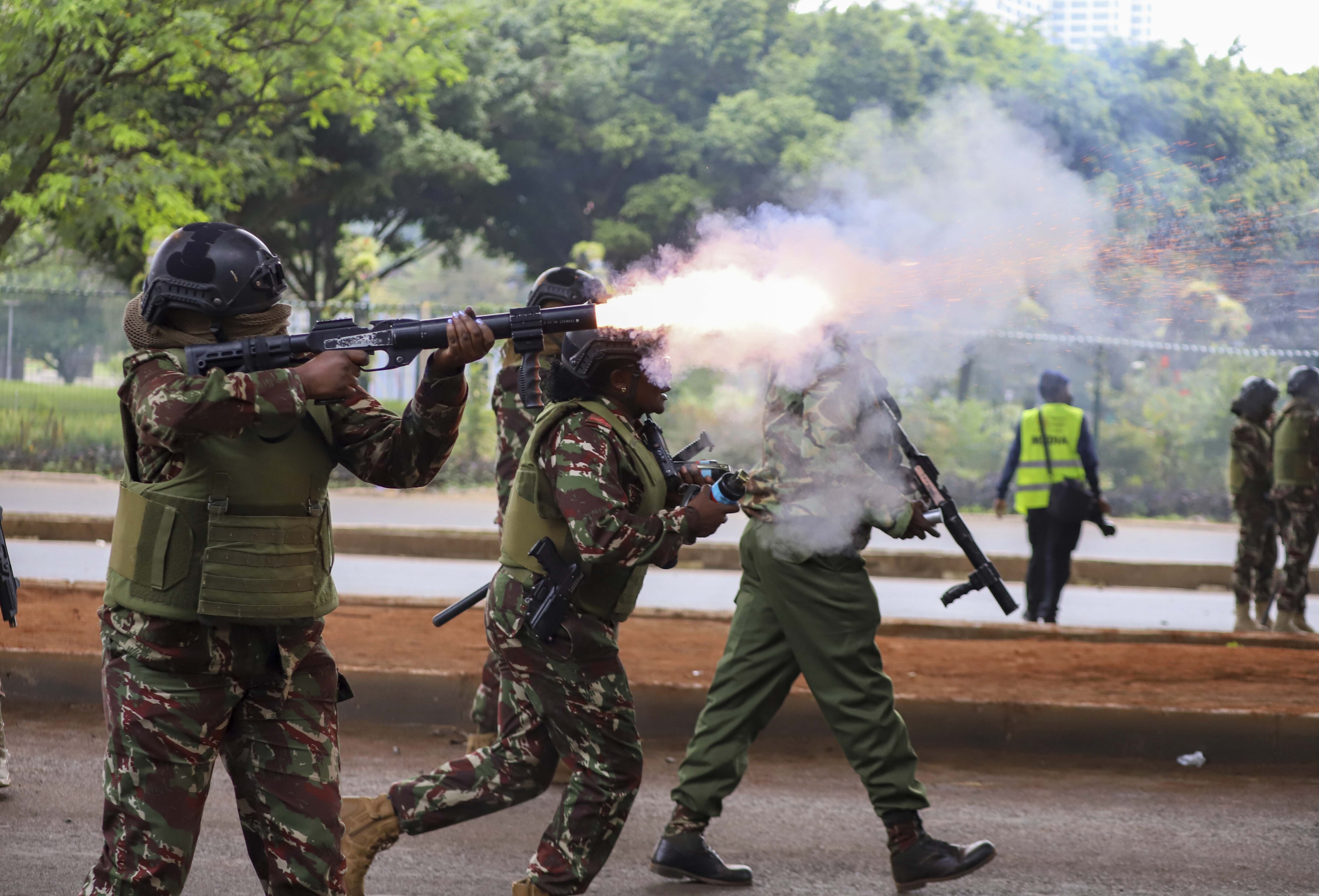 Police officers fire tear gas canisters during a protest over proposed tax hikes in a finance bill in Nairobi, Kenya, on June 20, 2024